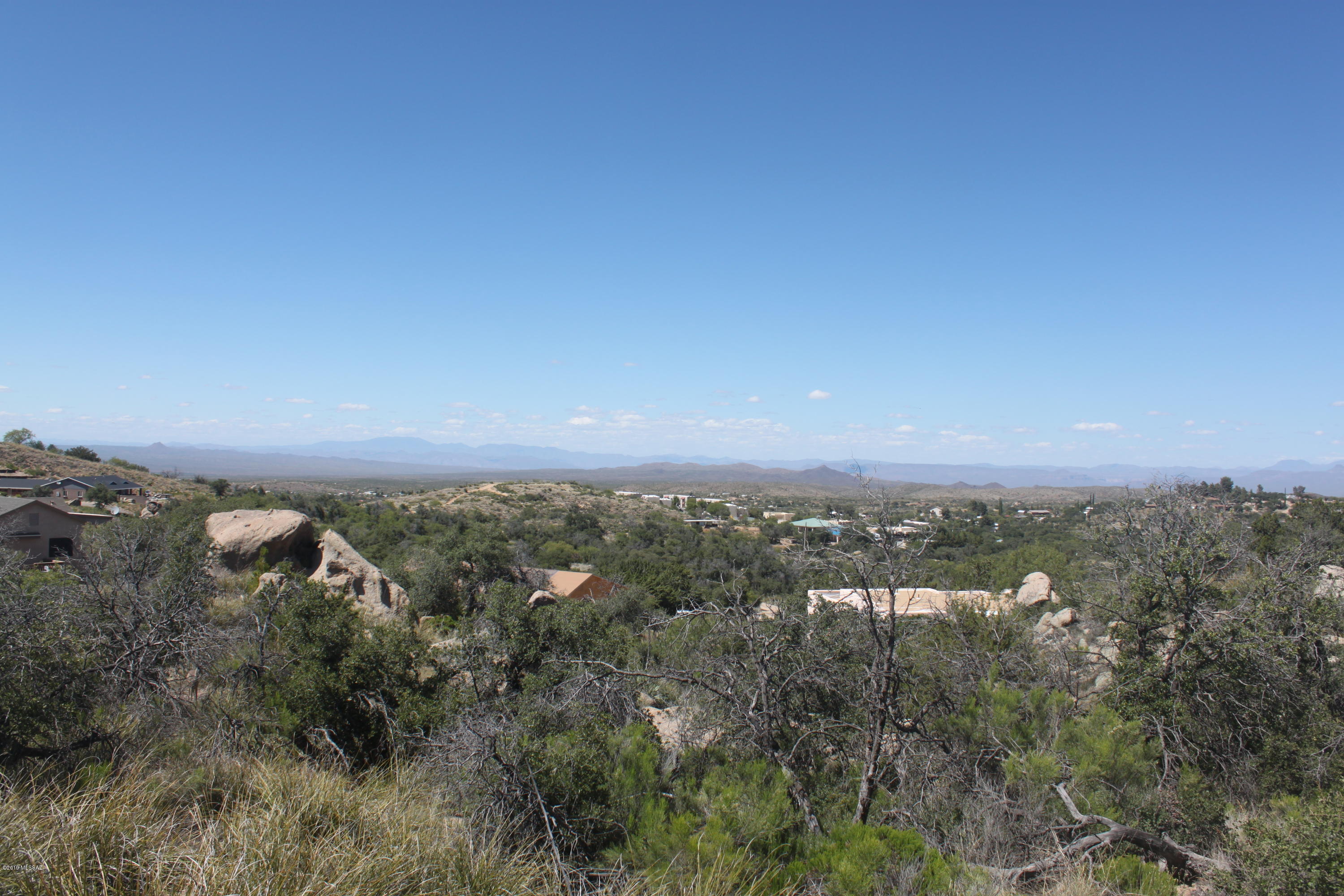 Check out the amazing views and boulders. Surrounded by custom homes. This is very easy access mostly paved and a short distance of well maintained gravel road.  Utilities at the line for an easy build. Enjoy Oracle's lush natural vegetation, big trees, cooler temps with occasional snow.