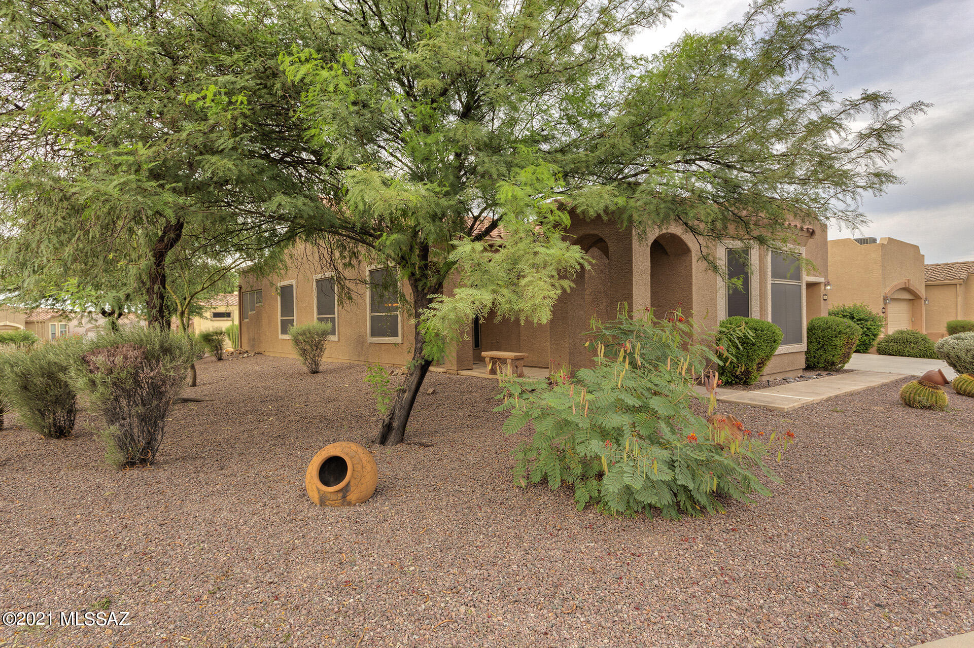 Easy living!  Stunning floor plan and the HOA takes care of the many services! Enjoy this home with 2 bedrooms-split,den, 2 bath, open floor plan with a chef's kitchen, vaulted ceilings and loads of storage. Tile flooring in all the right spaces, ceiling fans and extra can lights! Expanded 2 car garage with epoxy floors and storage cabinets.  New kitchen appliances, excellent cabinet and counter space and storage galore. Relax at the private screened patio or venture to the grassy park.  Bring some clothes and a toothbrush!  Super easy living awaits you!