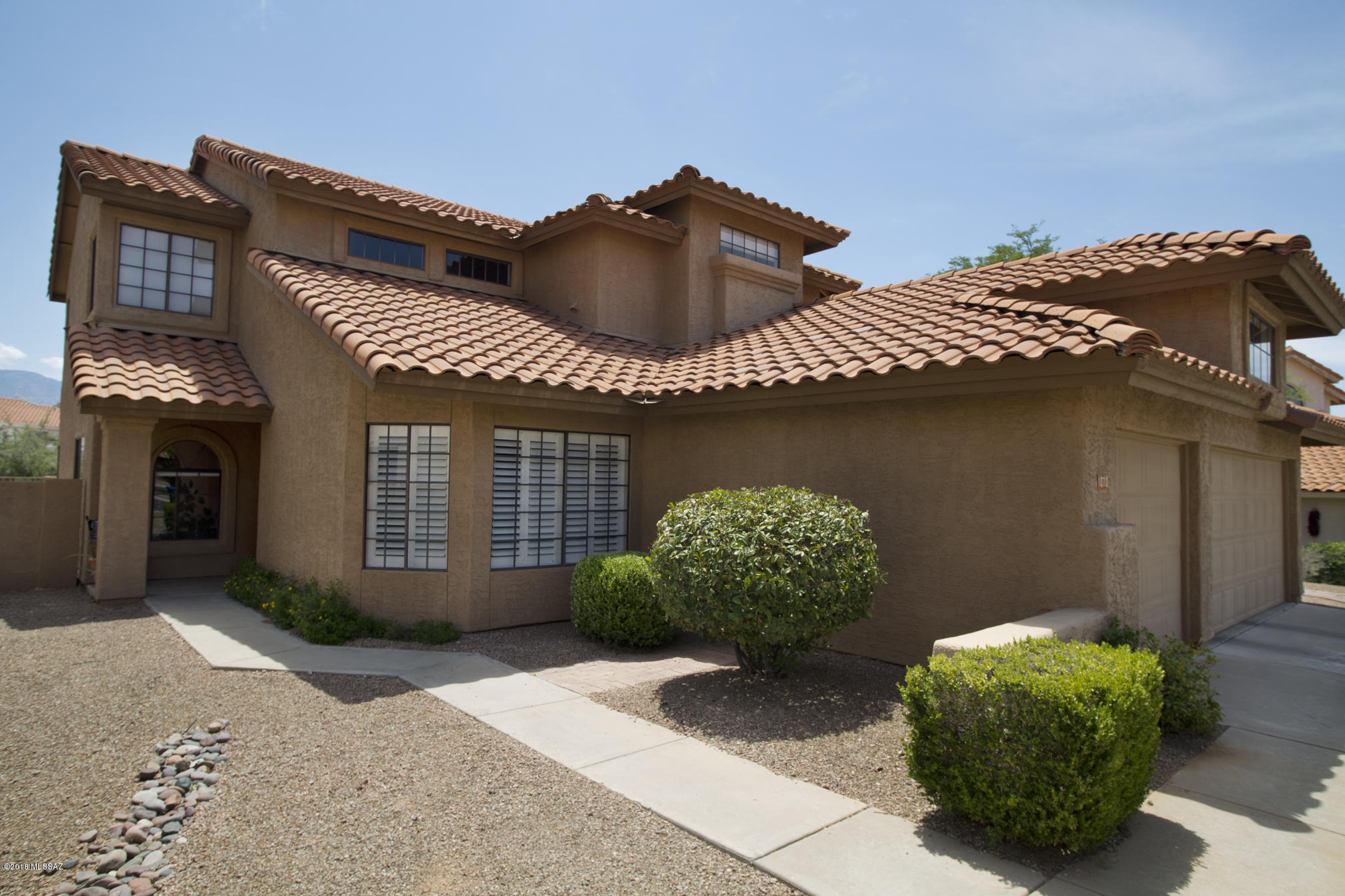 Wonderful contemporary Copper creek home on a PRIME lot with lovely views & adjacent to wash for privacy & nature! 4 bed/3 full baths in a well established neighborhood close to dining,shopping, schools! 3 beds up, guest/office downstairs. 3 Car garage for storage or room for toys. Cultured marble in the bthrms & a vaulted master suite w/slider & deck w/ beautiful views of sunrises & the Catalinas! Plenty of updates with NEW PLUMBING in 2016 (NO POLY), newer interior & exterior paint, new shower doors, refinished master shower floor, new Hunter Douglas shutters, newer bath/whole house fixtures (handles, hinges, knobs, stops, faucets). Wet Bar in great room is perfect for entertaining!Covered outdoor patio, grass in the yard, a basketball rim & concrete court & even a tortoise habitat!
