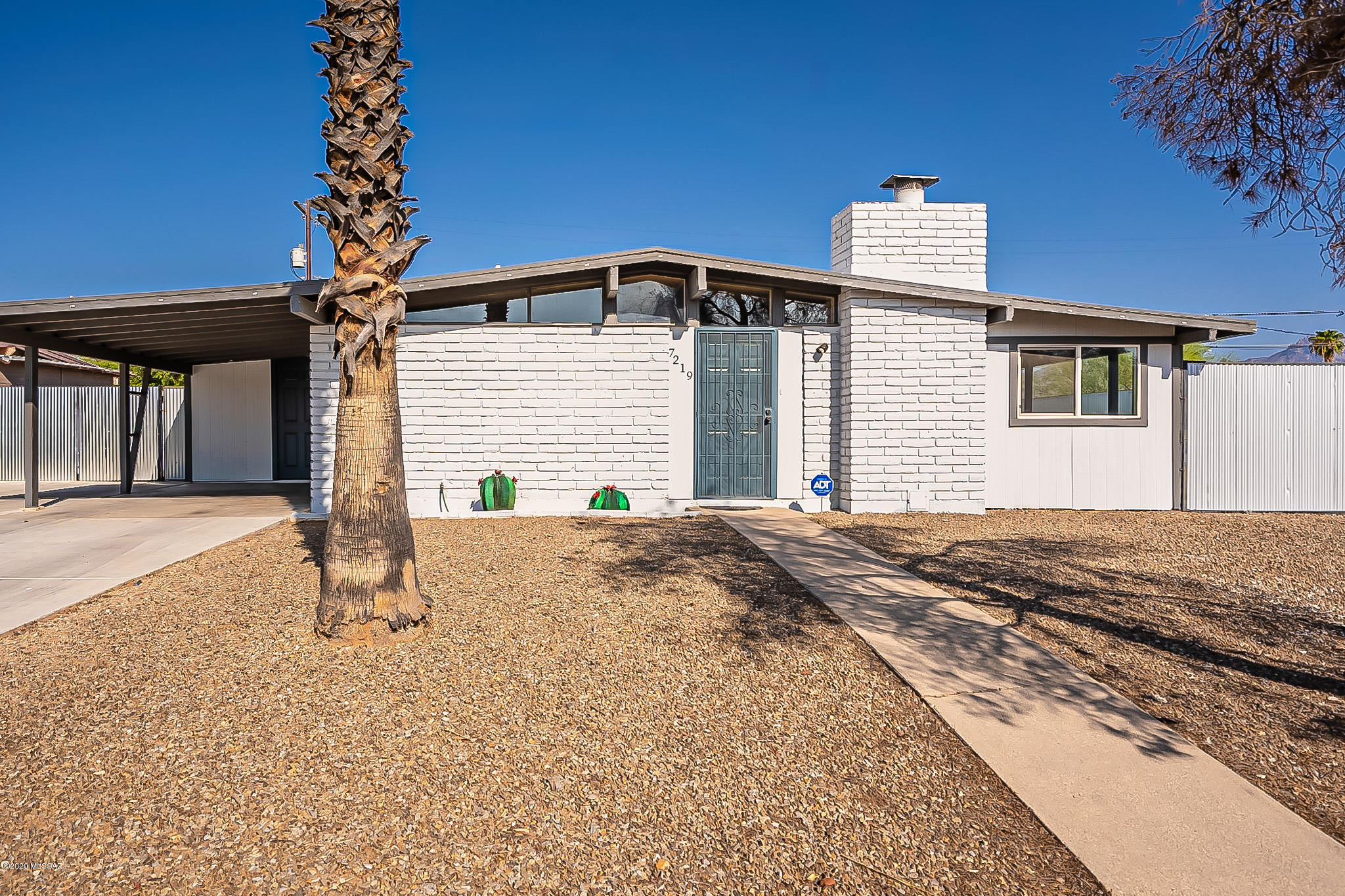 Wonderful Mid-Century 3 br 2 ba home in a stellar location!  This darling home features an updated kitchen with stainless steel appliance, finished concrete, and an island for convenience.  The great room has finished concrete floors, large wood burning fireplace and exposed beams.  BONUS feature...the back yard.  The oversized backyard features an extended paved patio, corrugated metal fencing, artificial turf and mountain views!  Come make yourself at home!