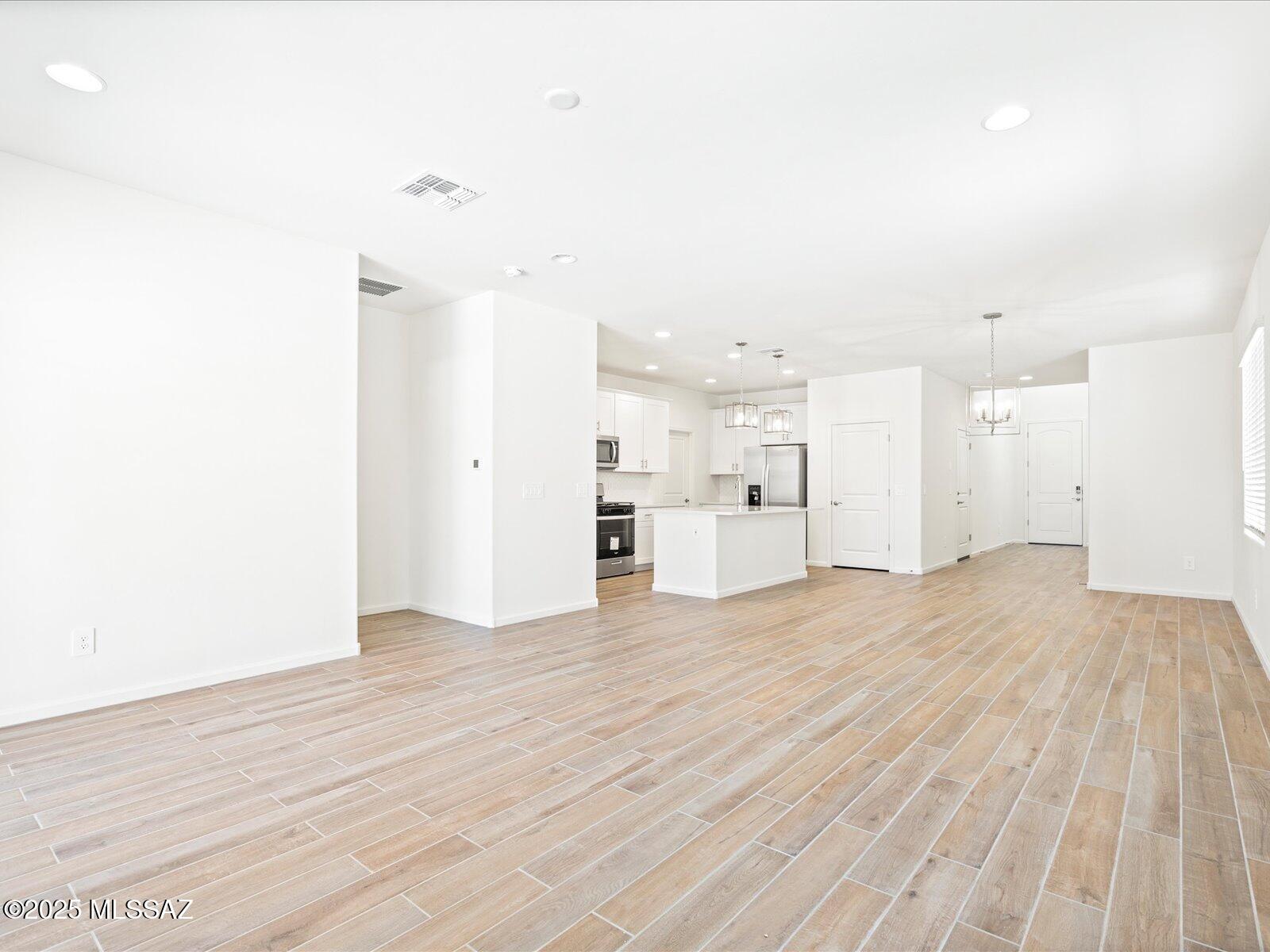 This 4-bedroom, 2.5-bath home blends style and function with a spacious open-concept layout downstairs—ideal for entertaining or relaxing in comfort. The kitchen shines with crisp white cabinets and elegant marble-look granite countertops, while wood-look tile flooring and neutral carpet add warmth and balance throughout.

Set against the breathtaking Rincon Mountains in the sought-after Hanson Ridge community in Vail, Arizona, this home offers access to the top-rated Vail School District and is just minutes from the I-10 and major employment centers.

Best of all, it's move-in ready with a washer, dryer, refrigerator, and whole-home blinds already included—just bring your personal touch.