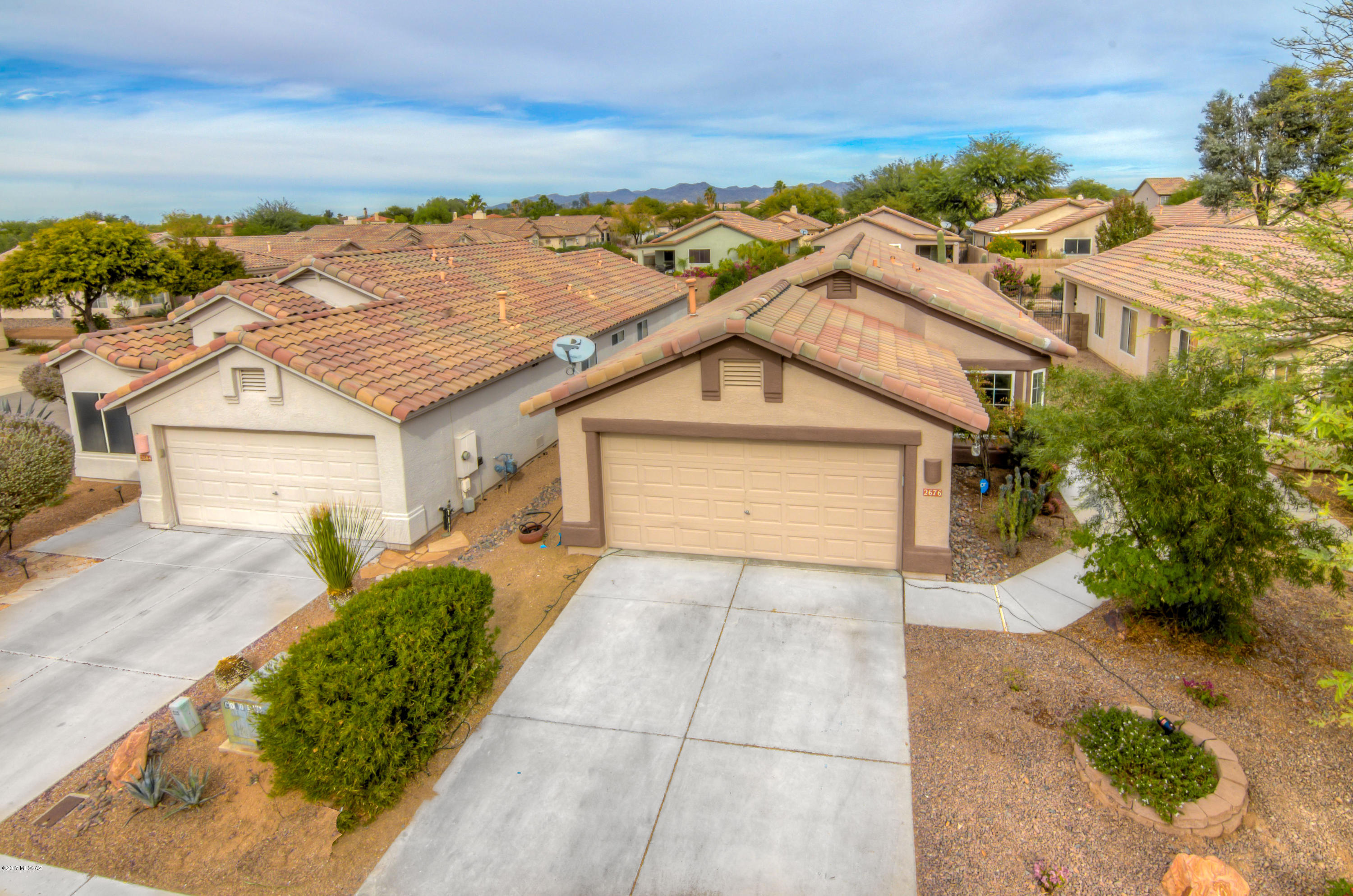 Well maintained and upgraded three bedroom, two bath home, in the Upper Bluffs in NW Tucson. This property features modern tile in the living areas, primary and accent interior painted walls, fresh exterior paint, upgraded dual pane windows, black kitchen appliances with upgraded kitchen cabinets and modern lighting fixtures. Relax in the low maintenance backyard which contains artificial turf, pavers and a covered patio. The Bluffs community features a neighborhood park with a basketball court, ball fields, horse shoes pits, bbq, covered patio and a playground.