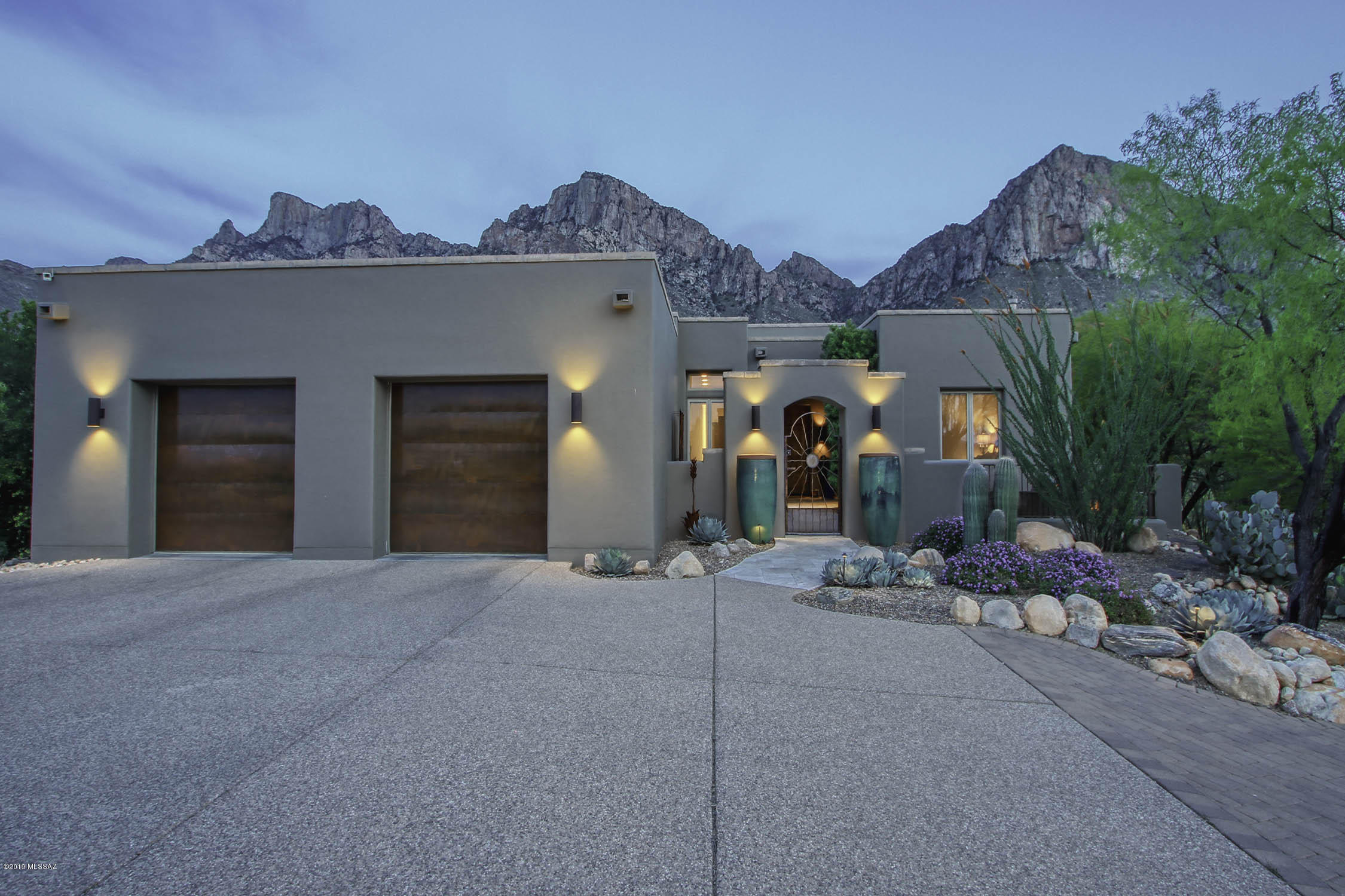 Stunning 3BD/3BA+Den (3,501 sq ft) custom hilltop estate designed by renowned architect Ron Robinette is located in the guard gated community of La Reserve. Set back on 2+ acres against the Catalina Mountains and bordering designated wilderness, this stately home boasts magnificent mountain and city light views throughout. Enter this private home through a courtyard and find walls of windows maximizing the view. Upgraded chef's kitchen with dining area. Private Master suite hosts an extended luxury bath. Added features include floor-to-ceiling concave brick wall, multiple fireplaces, split bedroom floor plan, paver driveway and more. Resort style back yard with extended rear patio, sparkling pool, kiva fireplace, grill station and professional landscaping. A must see. VIEWS, VIEWS, VIEWS!