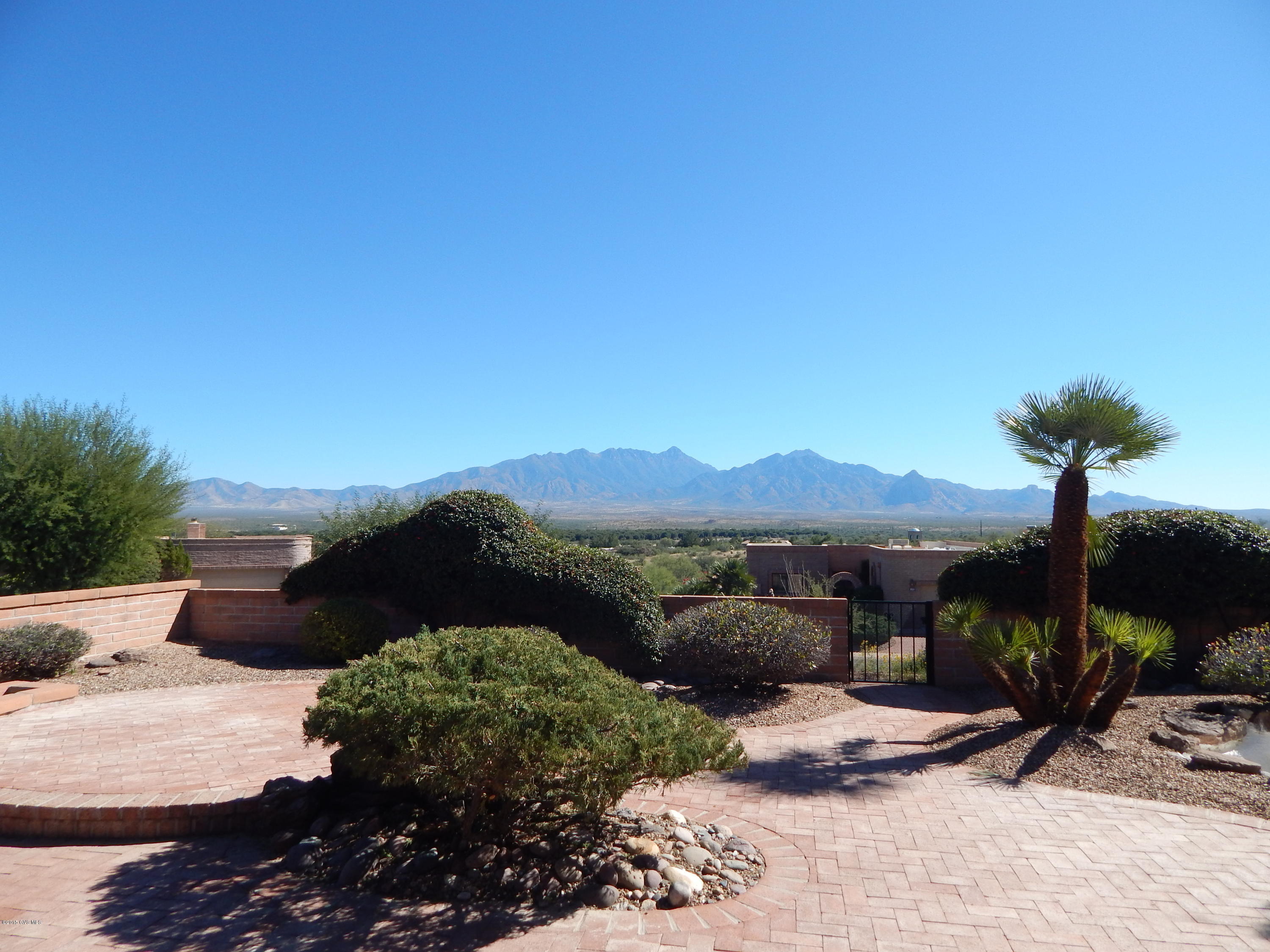 A lovely Miramar model with attractive wrap around covered patio on a desirable corner lot with excellent panoramic Mountain views! The home has neutral tile in the entry, hallway and kitchen. The kitchen has a breakfast bar and nook with a sliding door that leads to the warp around patio. The spacious living area has a brick fireplace, wet bar and sliding glass door that leads to the backyard. The master suite has a large bathroom with tub, separate shower and large walk-in closet. The backyard is well designed with lots brick work, a pond and ample space for relaxing and enjoying the private corner lot with soaring mountain views.