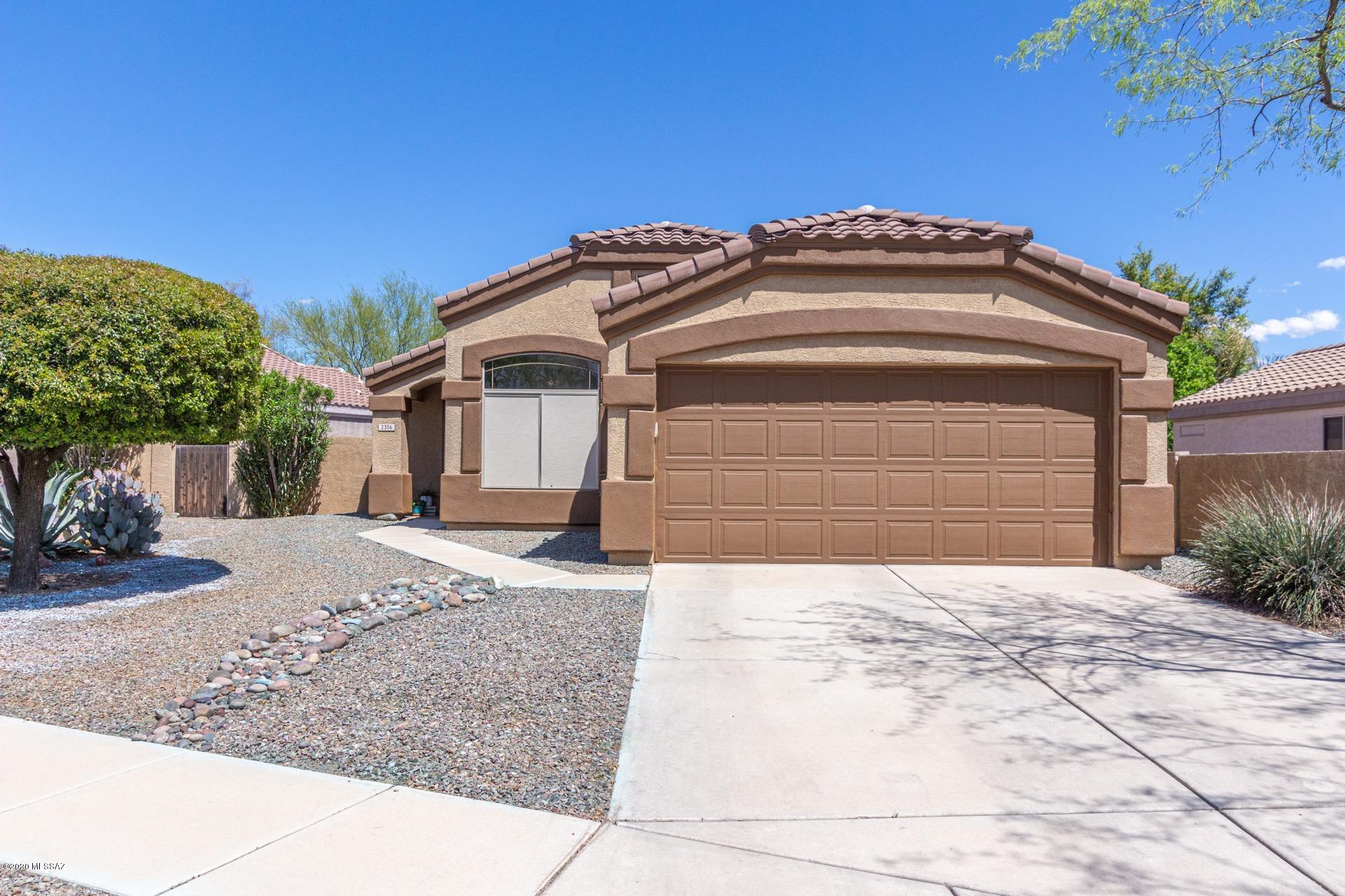Incredible 3 bed/2 bath home available in highly sought after Castle Rock. Superb east Tucson lake community with amenities including a pool and spa, exercise facility, tennis, basketball courts and more. Impressive interior is sunny and inviting with soaring vaulted ceilings, plant shelving, custom paint tones, wood look tile and carpet in all of the right places. Spacious living area is enhanced with a charming fireplace. Eat-in kitchen boasts granite counter-tops, jet black appliances and an island. Master retreat includes a walk-in closet, a private en-suite and great views of the amazing backyard. Here you will find beautiful landscaping, a covered patio and a sparkling pool, a perfect spot to enjoy outdoor living in Arizona. This gem is a must see. Call for your showing today.