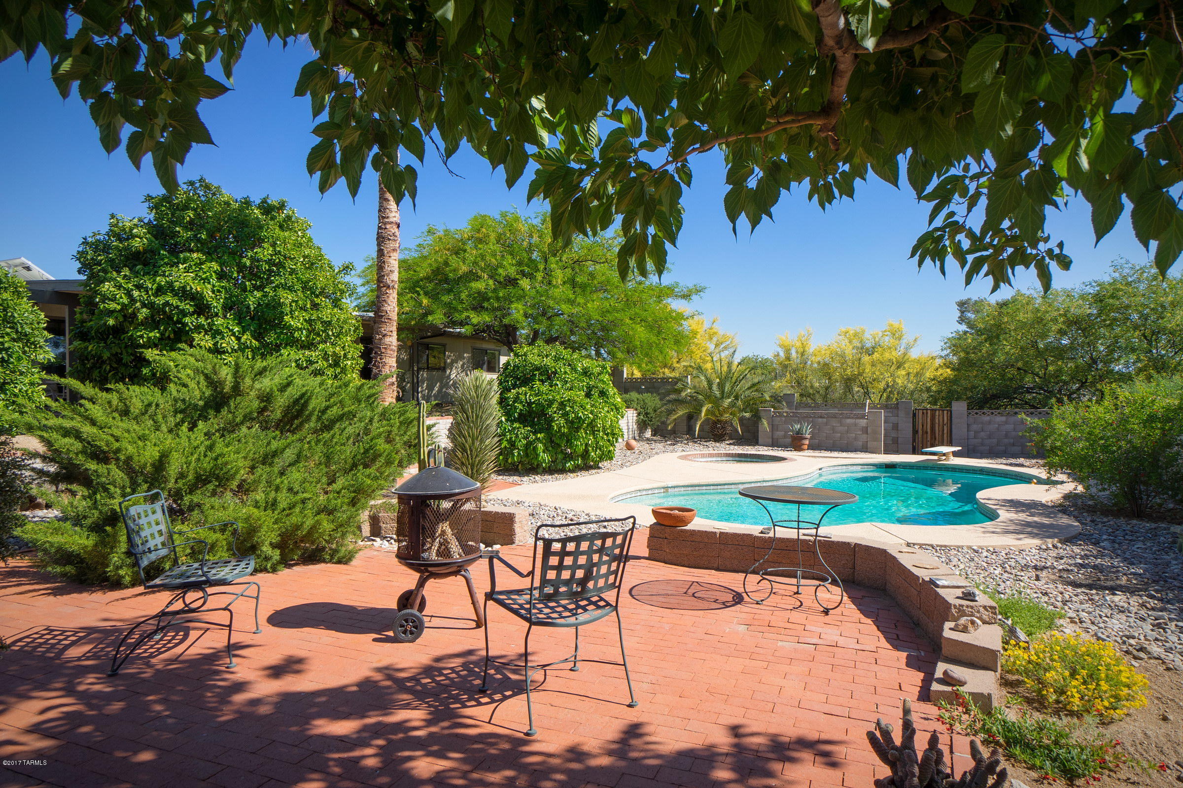 Imagine having an electric bill of only $20 a month all summer long ? This solar efficient home is a rare gem on a spectacular lot!!!  Come check out this desert oasis that sits on the highest lot in the popular Discovery Ridge Subdivision (where few homes come on the market). You will fall in love with the back yard w/HUGE covered patio, spectacular mountain views (on a clear day you can see Kit Peak), fruit trees, plenty of room to garden, and a sparkling pool ! Rain Barrels will help capture the rain. You will have plenty of room to park your boat or toys on the half acre lot. Check out the roomy kitchen w/island, lots of storage, newer windows, newer Trane  HVAC, large expanded bedrooms, all sitting on a cul-de-sac!  Hurry, this is a rare opportunity for you to live in Discovery Ridge. Solar is completely paid for !  NRG leases the panels from the owner - and this lease is transferable !  It generates all of the energy for the home, and once a year the home owner gets a check for extra energy that was produced but not used by owners.  The only cost for electricity is less than $20 a month to be hooked up through TEP.  NRG is leasing back from current owners, and they are into the 6th year of a 20 year lease !  This is a real benefit to this extraordinary home !  Solar information is attached to this listing along with other great information.
