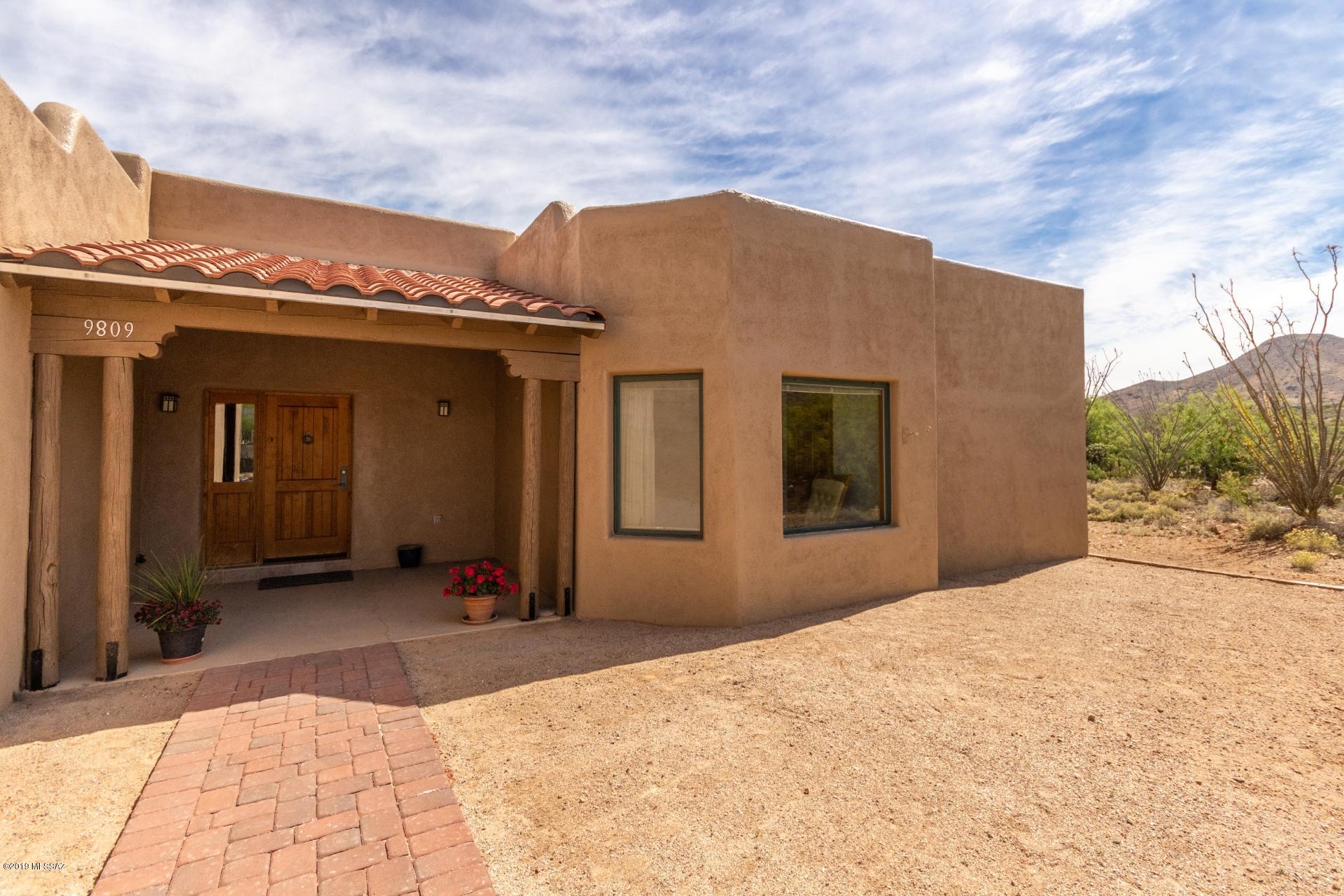 Gorgeous single story, 4 bedroom southwestern home on  4+ acres of beautiful land in quiet Vail, AZ. Enjoy the serenity of wide open spaces & breathtaking mountain views all within easy reach of metropolitan conveniences. Inside is bright & very well maintained. Perfect for entertaining, the open floorplan offers a spacious living area featuring pristine tile, a charming fireplace & large windows allowing for an abundance of natural light. Eat in kitchen presents ss appliances, white cabinetry, granite countertops & a sunny bay window dining nook. Master ensuite with dual sinks & separate tub and shower. Sprawling backyard is complete w/ a covered patio, ideal for savoring the spectacular views. NO HOA! This gem will  impress!