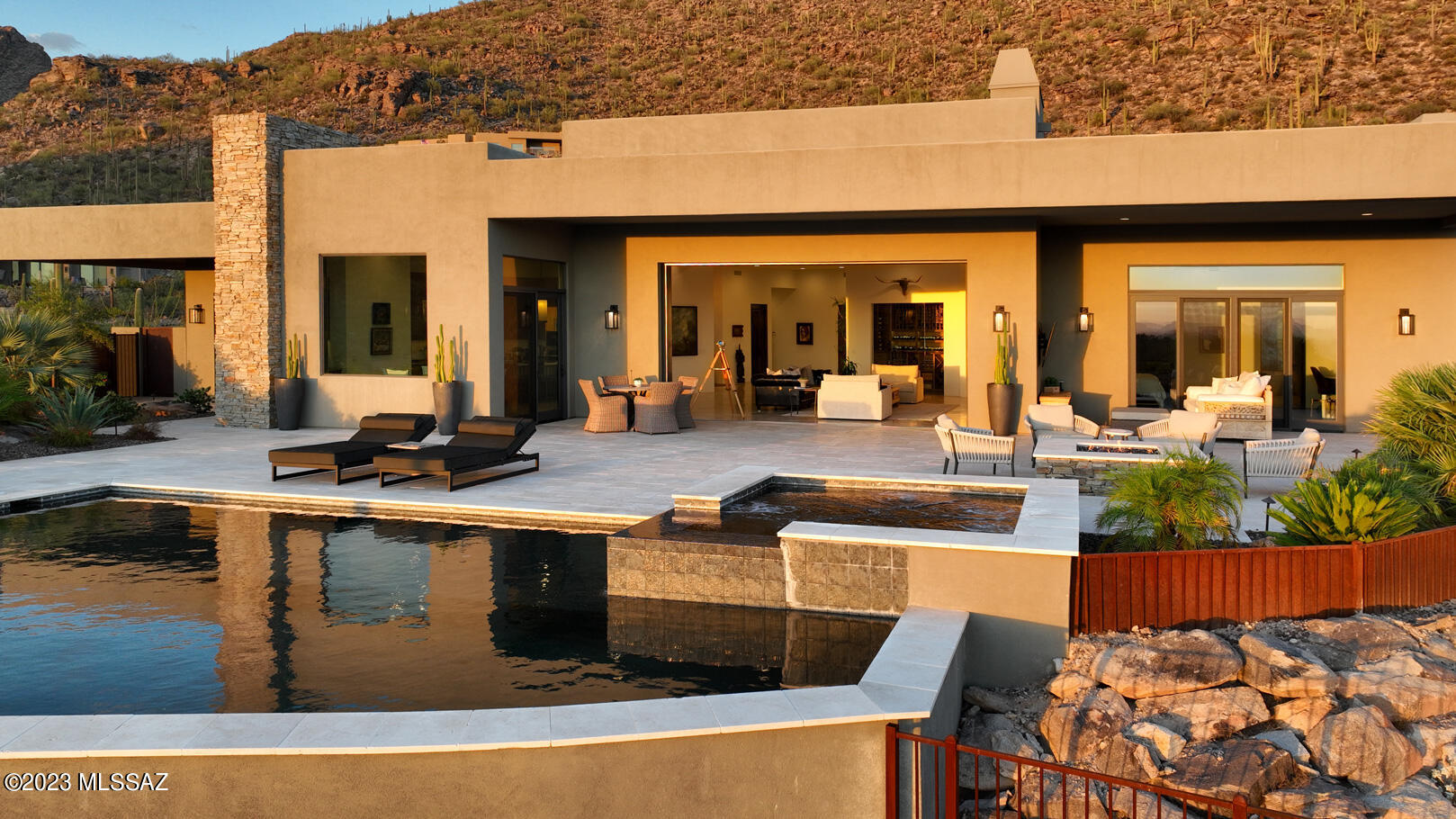 Indulge in panoramic perfection! Nestled in the prestigious enclave of Dove Mountain in Oro Valley, this magnificent residence offers a lifestyle of unparalleled luxury and sophistication. Perched atop an elevated corner lot, this property affords you the utmost privacy. As you step inside you'll experience an unobstructed, 100-mile panoramic view that stretches as far as the eye can see, with sunsets painting the sky in vivid shades of crimson and gold, draws you in. The meticulous attention to detail and thoughtful design choices throughout this home is immediately evident as travertine floors flow seamlessly through the kitchen, main living areas and patio providing a timeless, natural aesthetic. Leathered granite kitchen counters, custom black walnut cabinetry, and glass walls.

Outdoors, the black bottom pool with black onyx Pebble-tech exudes luxury and elegance, while the BBQ center complete with a wall and built-in planters is perfect for entertaining. The courtyard entry has been refreshed with mature trees and landscaping providing a natural beauty and shade around the property. 

Situated within a community renowned for its championship golf courses and the world-renowned Ritz-Carlton Hotel, this home is a testament to the epitome of desert living. The Gallery Golf Club and its exceptional clubhouse facilities, complete with sports amenities, are right at your fingertips, promising endless recreation opportunities. 

Some of the many highlights of the home include a Pelican whole-house water treatment and softener system, guaranteeing the purest water quality, a six-car garage, a lavish spa-like primary suite, a fully snake-fenced perimeter, a comprehensive landscaping irrigation system, Savant smart home system, Lutron Lighting, Lutron sunshades, Cat5 wired Ring doorbell and AV surge protectors. With exquisite custom touches, elegant finishes, and cutting-edge technology, this house on the hill offers the ultimate desert retreat for its next owners. Make this breathtaking residence your own and experience the pinnacle of Dove Mountain living. Welcome to your new paradise.