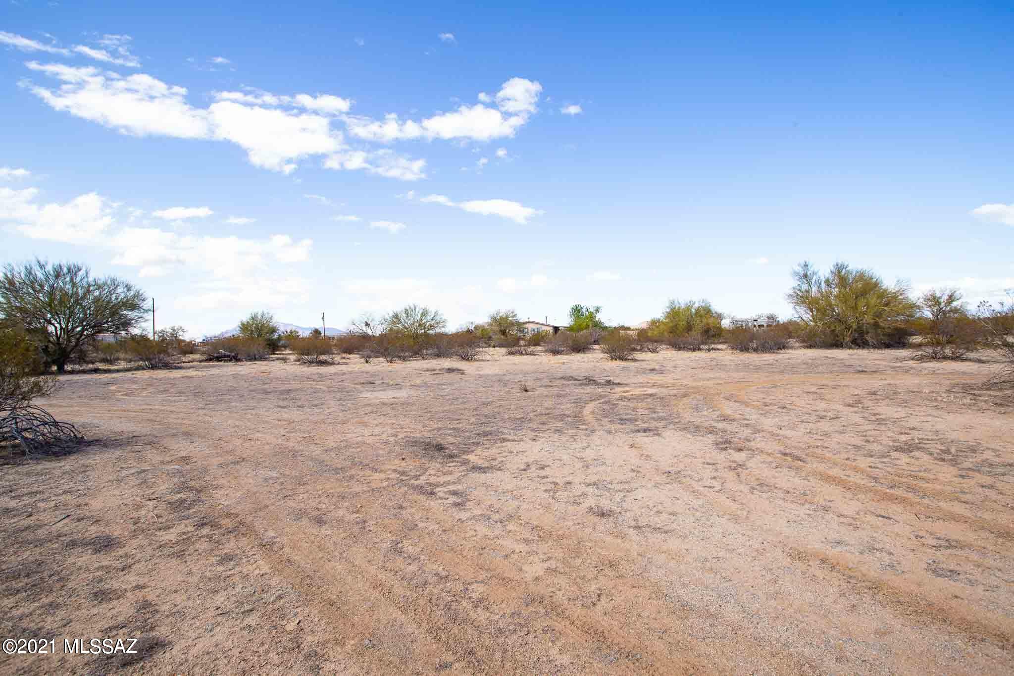 Enjoy Country living at its best on these 2.35 acres of flat land, tranquil horse property with water, electric and phone. No HOA. Ready for your Manufactured home or site build. Backs up to Federal land. Surrounded by wide open spaces and sweeping views in all directions. Ideal for hiking, biking, and trail riding. Just 5 minutes from I-10, easy commute to Tucson or Phoenix.