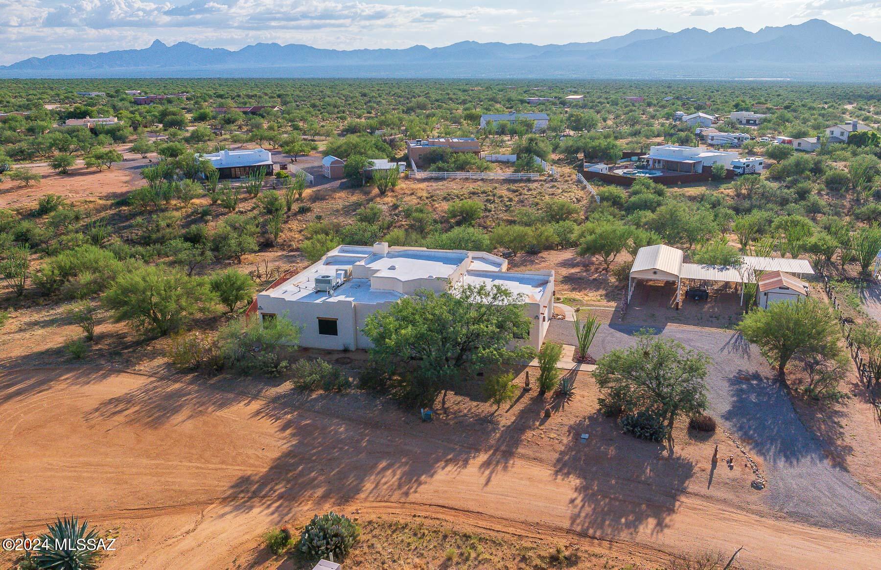 Your destination for living a wonderful tranquil life is Diamond Bell Ranch in a beautiful Sonoran Desert setting! Enjoy the desert wildlife from your large rear patio, as well as beautiful sunsets and mountain views. Bring a telescope to fully appreciate the star-filled night sky. This Santa Fe style home has been lovingly cared for, with an upgraded kitchen featuring Corian Counters and top-of-the-line new appliances. New beautiful Anderson Windows and upgraded patio doors have been installed. The full-length covered patio includes a ceiling fan and a swing for enjoying those stunning sunsets. The property also boasts an oversized garage, an RV carport with electric and water hookups, plus additional carports for vehicles and riding toys. There is also a workshop/storage building with power, a roll-up door, and a side entry door. Please refer to the additional document for more information.
