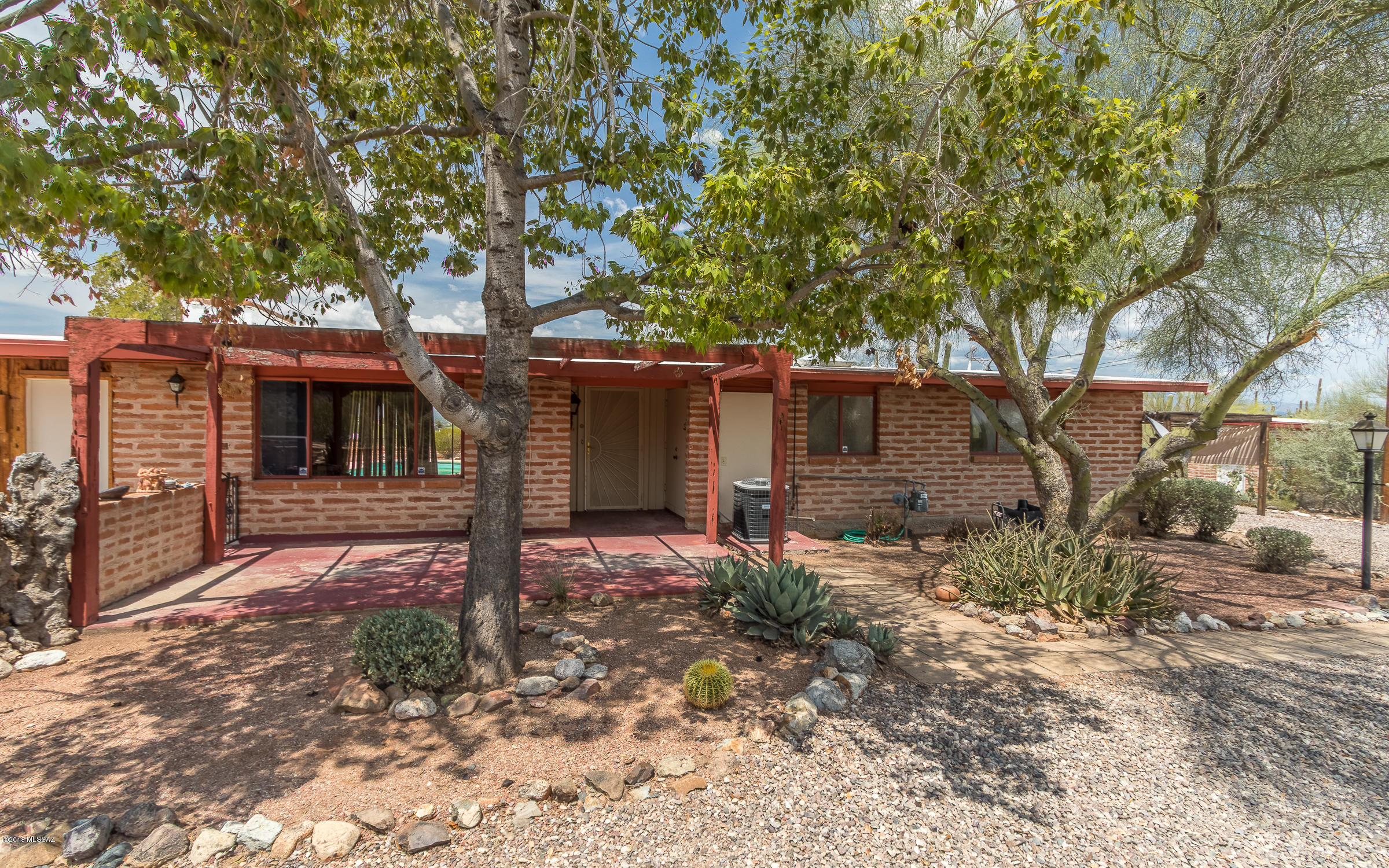 Slump block home features 1 bedroom and 1 bathroom with attached casita with kitchen and bathroom, for a total of 1586 Sq. Ft. Needs TLC but the bones are good and the mtn. views are fantastic! Wood burning fireplace in L. Room of home. Saltillo tile and carpet flooring. Tile countertops in kitchen and bathroom. Bathroom features tile shower and garden tub. Conventional swimming pool out back with beautiful views of the Catalina Mtns. and lush desert surroundings! Out front is a lg. flagstone outdoor area with a brick BBQ. Detached 22' x 16'
slump block outbuilding on property as well. HVAC unit is 5 yrs. old. Roof was re-coated 2 yrs. ago. Sweetwater Reserve is out your back door w/horse back riding, Mtn. biking and hiking. K-8 schools 10 min. walk. 10 min. to I-10, 15 min. to downtown. Home appraised for $240,000 in June of 2018.