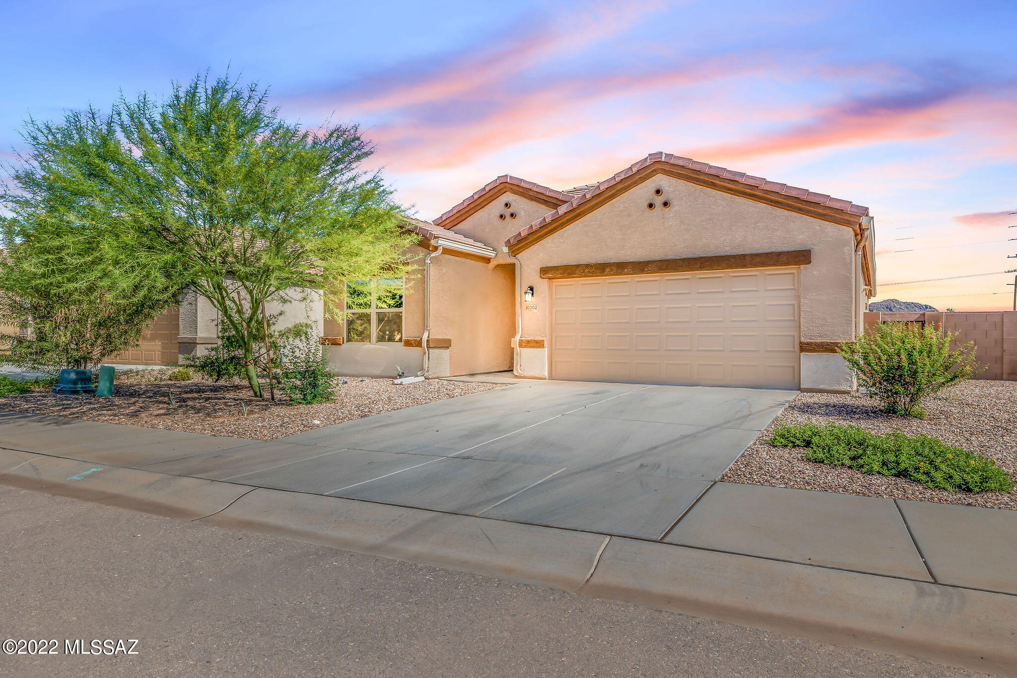 ASSUMABLE LOAN OF 3.625% option available for this Beautiful 2019 build in the Saguaro Bloom community. Well cared-for and maintained home with open floor plan, Island kitchen, tile and carpet throughout.  Backyard includes pavers and easy-care turf with a pergola perfect for entertaining friends and family. Black kitchen appliances and refrigerator convey with sale. Reverse Osmosis available at kitchen sink. Laundry room with washer/dryer included. ADT alarm system installed and can be transferred to new homeowner and video doorbell. Tankless water heater. Enjoy the privacy of your home, as it's right next to greenbelt. Community splash pad, multiple pools, community center. Gym facilities. Walking trails, paved street and sidewalks. Basketball court. Ask HOA about planned extensions in the community! Master bedroom curtain rods, curtains, and master bathroom main towel rack does not convey with the home sale. A MUST SEE! MOTIVATED SELLERS!