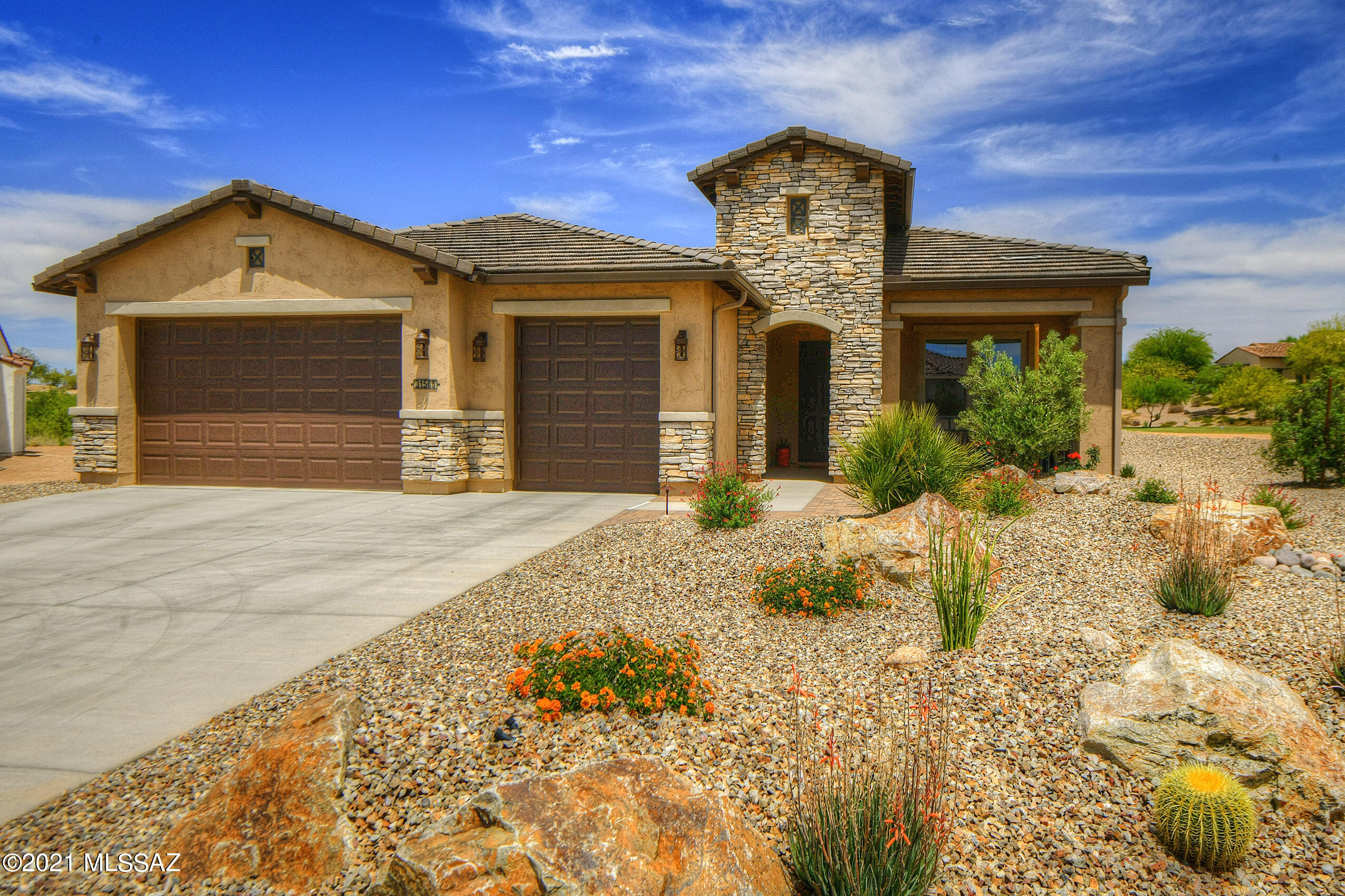 Loaded with upgrades, this stunning 2BD/2.5BA +Den (2,779 sq ft) contemporary Avalon floorplan is situated on golf course and boasts assorted mountain views. Open concept Great room plan for modern living features 12x24 Italian porcelain tile and coffered ceilings. Chef's kitchen offers a large island, quartz countertops, stainless appliances, butler's pantry, prep sink & large dining nook with built-in buffet. Owner's suite hosts a luxury bath with large tile & glass walk-in shower. Second bedroom has in-wall bed & En suite bath with shower. Large den/office with storage closet in hall. Huge laundry w/ extra storage. Front covered porch with wrought iron railing plus rear covered patio with extended pavers, built-in BBQ and fireplace. Colorful landscape has fountain, turf and garden bed.