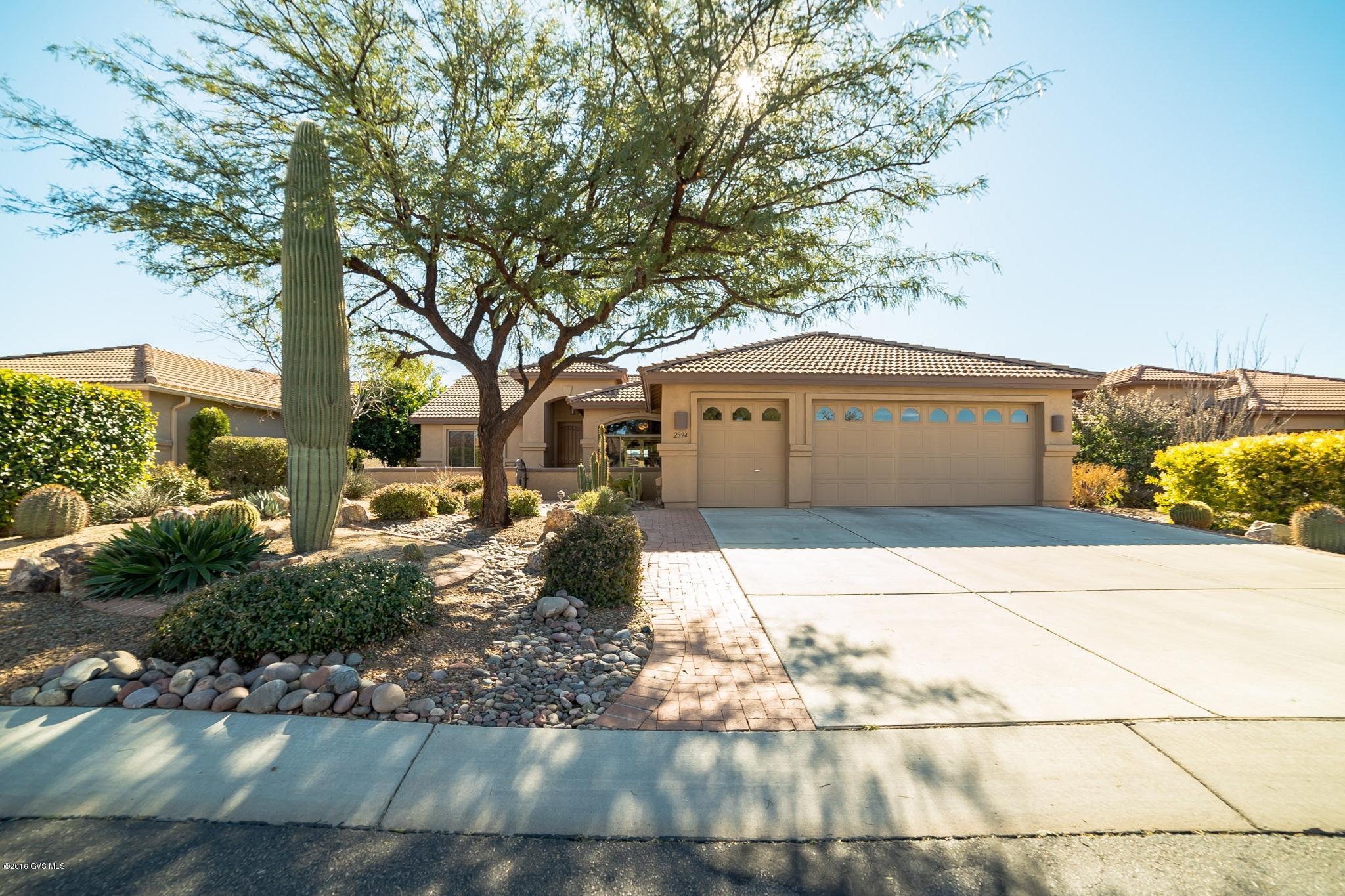 This expanded Laredo model is in a location that is all about privacy. The home sits above an arroyo with straight on views of the Santa Ritas. The large covered patio is the perfect entertaining spot or a place to kick back and watch the mountains turn pink. This home contains many custom features. The garage has a golf cart space and has been extended for lots of storage. The floors are tile and hardwood. The custom walk in shower in the Master Bath is an added bonus as is the Master bay window. This home has been meticulously maintained and has a spectacular location. Be sure to put this home on your list for viewing.