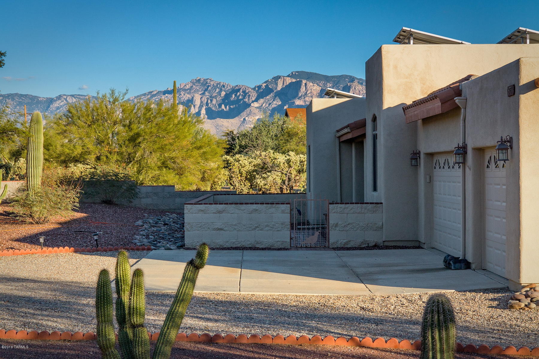 The one you have been waiting for! Settled on just over an acre, this beautiful 3 bedroom, 2 bath southwestern style home features a pool with Catalina Mountain views, a 3 car garage, covered RV parking and loads of upgrades.  Great room offers high beamed ceilings and beehive fireplace, and separate formal dining with 8 ft. glass french doors can be completely closed off  and repurposed as a den or extra living space.  Prepare dinner like a chef with the stainless steel double oven gas range in the fully equipped kitchen.  Master suite features huge walk in closet, bath with oversize walk in shower and private access to patio. Lots of skylights and clerestory windows, thoughtful oversize travertine look tile in living and wet areas & tumbled stone tile finishing in baths and kitchen.