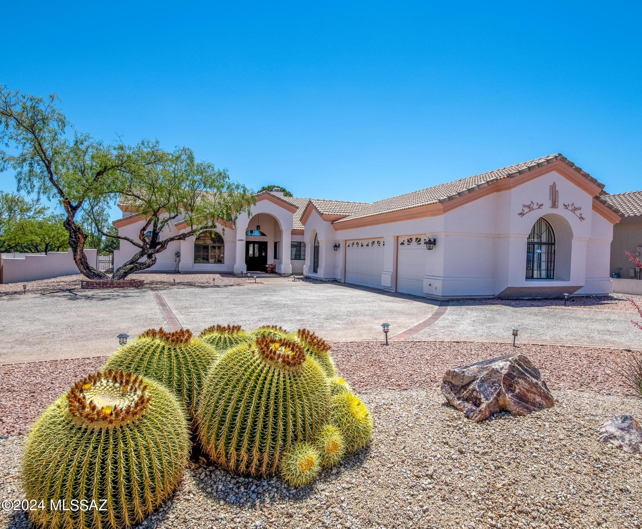 Gorgeous 2,657 sqft, 3+ bedroom, 2.5 bath custom home adjacent to golf course w/fairway gate! Fantastic great room w/vaulted wood ceilings, exposed hewn beams, & dual-faced gas fireplace. Carpet & classic Sotillo tile. Formal dining, bonus rm w/double doors & closet, w/guest half bath off great room. Amazing kitchen boasts lengthy Corian countertops, custom wood cabinets, island, & breakfast bar. Cooktop, microwave, & double ovens. Split floorplan offers guest room privacy and nearby laundry room w/cabinets, sink, & closet. Expansive master bedroom features patio access, large bathroom w/double-vanity, jet tub, separate tile shower, & big walk-in closet! Large extended 3-car garage w/cabinets. Amazing backyard oasis, covered patio, flagstone, irrigated raised beds, and views!