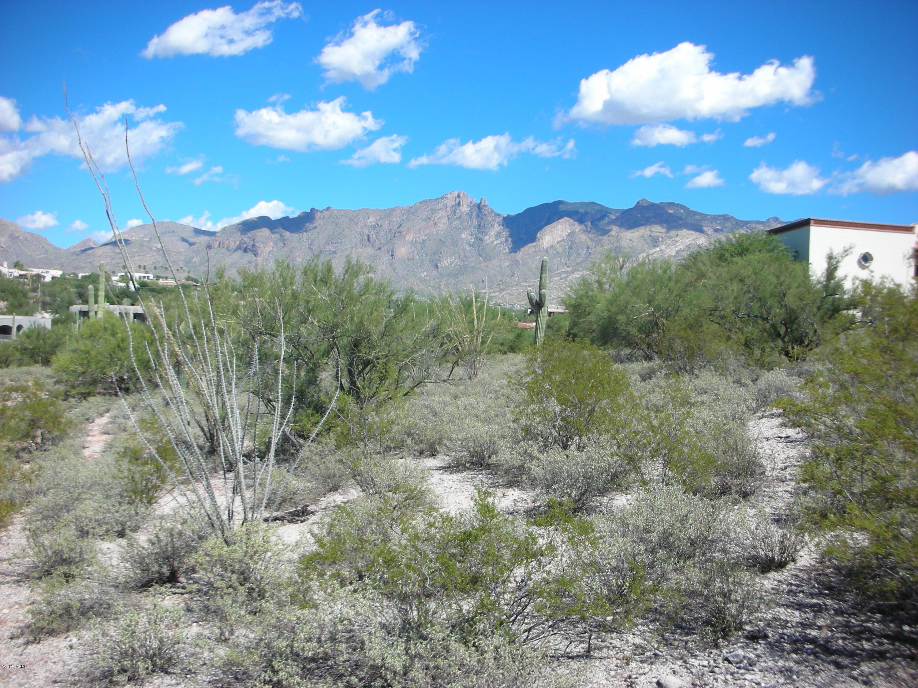 VERY RARE, CENTRAL FOOTHILLS, 2.5 ACRES in Gated LA PUERTA on HACIENDA DEL SOL. DRAMATIC MOUNTAIN,CITY & SUNSET VIEWS from a gently sloped, EASY BUILD SITE in a PRIVATE COMMUNITY of only 10 homes. Previous perc test available. You'll love the convenient and easy access to the University of AZ and Downtown Tucson as well as all the wonderful FOOTHILL'S AMENTIES. Call for gate code and GO SHOW the LAST UNBUILT, neighborhood site.