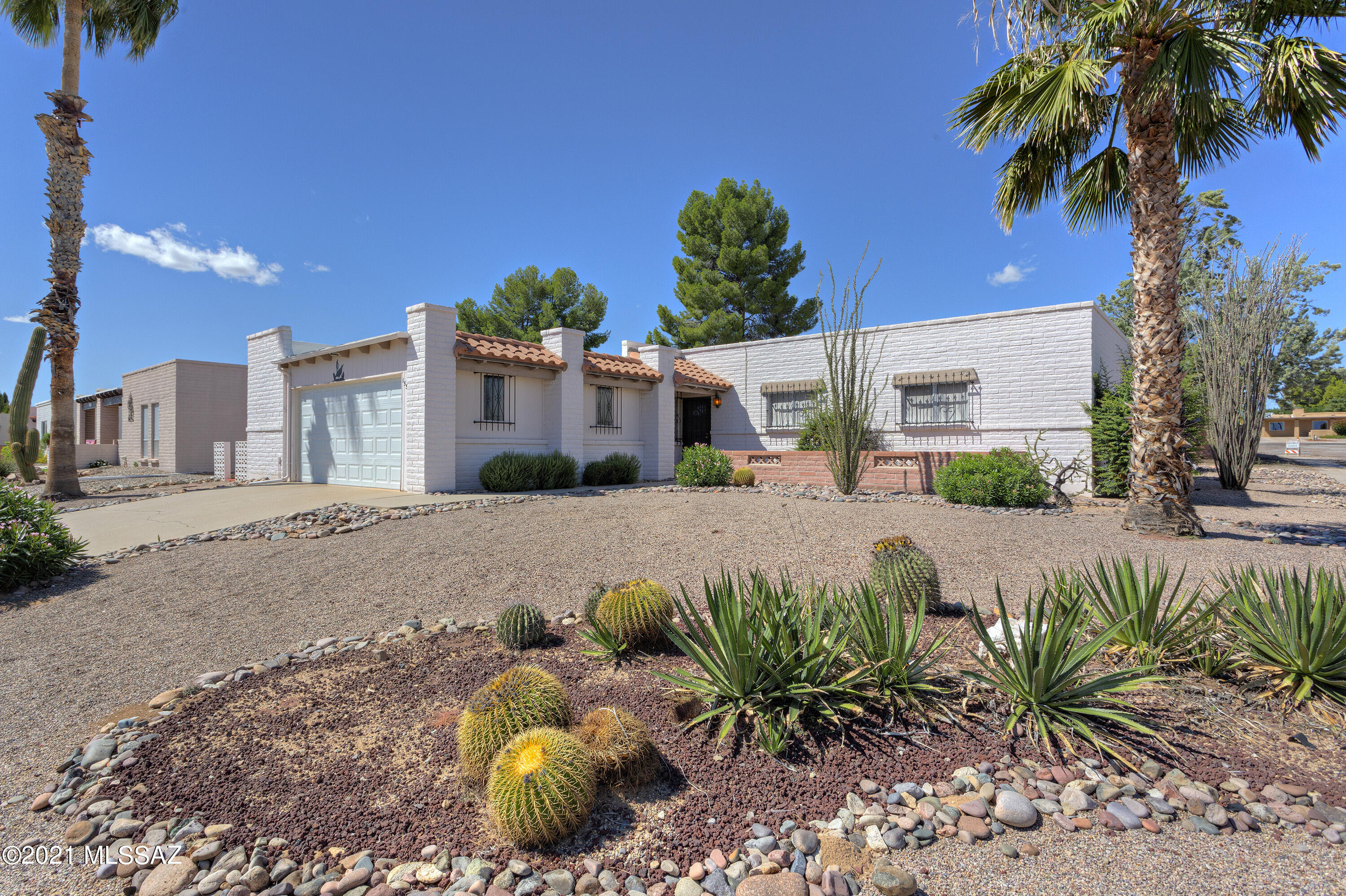 Bring your imagination and turn this ''diamond in the rough'' into your very own sparkling gem! This spacious (1877 sq ft) block home offers 3 bedrooms, 2 baths, and a 2-car garage and is situated on a corner lot with Santa Rita mountain views!  Inside you'll find an enormous living area perfect for entertaining, an efficient eat-in kitchen, a huge master suite with dressing area and double closets, two additional roomy bedrooms with ample storage, and an inside laundry room with washer and dryer.  The garage offers a newer door & spring, storage room, and attached cabinets too!  Located in a friendly HOA with minimal dues ($20/yr), this property is within walking distance to one of the many GVR facilities and Desert Meadows Park.  Hurry...at this price, this ''jewel'' won't last long!