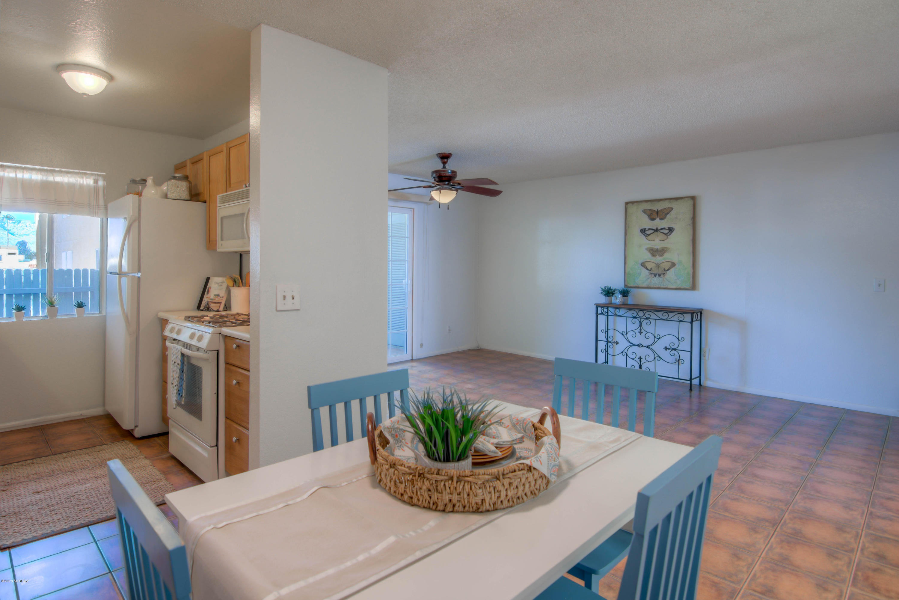 Move-In Ready 1st floor condo w/mountain views in charming east side community! You'll love the updated kitchen & baths as well as new lighting & fresh paint! Tile floors throughout & on the patio. Kitchen features gas stove, built-in microwave, fridge, dishwasher & good amount of cabinets. Ceiling fans throughout. You'll love the large soaking tub in the hall bath & updated vanity. The master suite has a roomy shower w/decorative tile, updated vanity & walk-in closet. Community offers 2 pools, jacuzzi, tot lot, termite service/pest control, common area maintenance & landscaping, plus large laundry room. Also water, sewer, trash & recycling included in HOA dues. Perfect turn-key opportunity--near shops, restaurants, schools, just a few miles from Amazon & Davis-Monthan AFB!