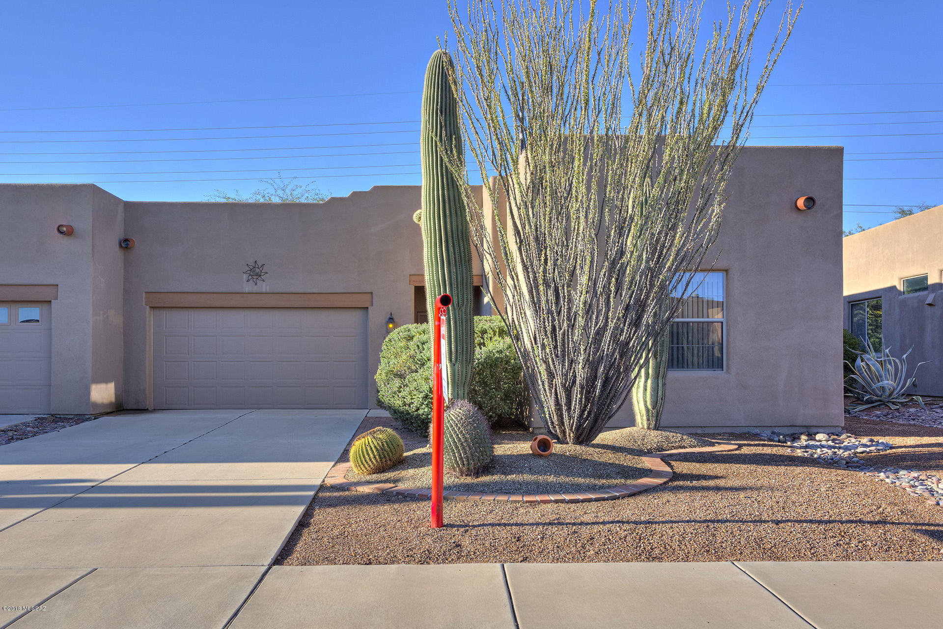 Beautifully cared for 2BD/2BA townhouse in gated Green Valley community.  Open floor plan, neutral colors. Galley kitchen with breakfast bar. Good sized bedrooms. Spacious enclosed backyard with large covered patio, extended pavers and mature vegetation offers tranquility and privacy. 2 car garage.  Competitively priced, will sell fast. 55+ community, in GVR.