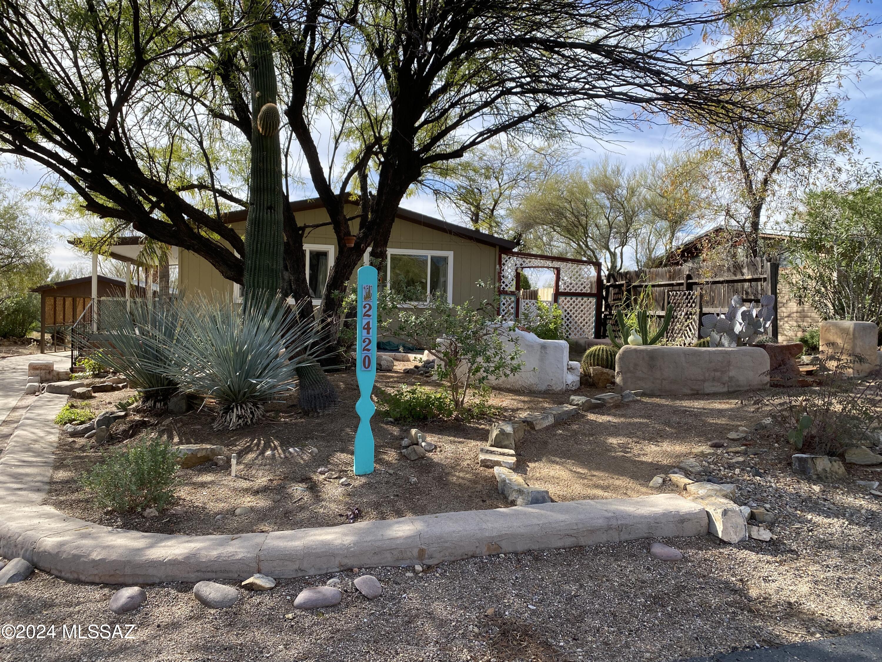 Come visit this spacious 2 bedroom, 2 bath home with open floorplan and outside areas for entertaining. The home is located in a community where you own your land and can enjoy the recreational facilities provided by the HOA. The TE 1 HOA offers TE 2 homeowners access to their 18 hole executive golf course at a daily rate of $25 per person. This home is located near the entrances to Tucson Mountain Park where there are many hiking and bike trails with views of the the majestic mountains.  Come enjoy the beauty of the desert and park surrounding this community and the views from your own back yard porch looking out on open common area and the TE 1 golf course.