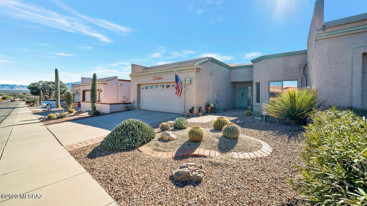 Golf & Mountain Views from your townhome patio on Torres Blancas Golf Course.  2BR/2.5 Baths, great room, Tiled, inviting Gas Fireplace, Southwest flavor with archways, pot shelves, niches, clerestory windows, and more.  Dine-in Kitchen with newer Refrigerator.  Townhome comes furnished (at no value) per Inventory List.  All appliances included.  French doors with Built-in Blinds give you privacy, light control, and convenience.  Step out onto the back patio where you can enjoy the Santa Rita and Golf Course Views!  Two - Car Garage has utility sink, work bench/tools, and Built-in Storage Cabinets.
