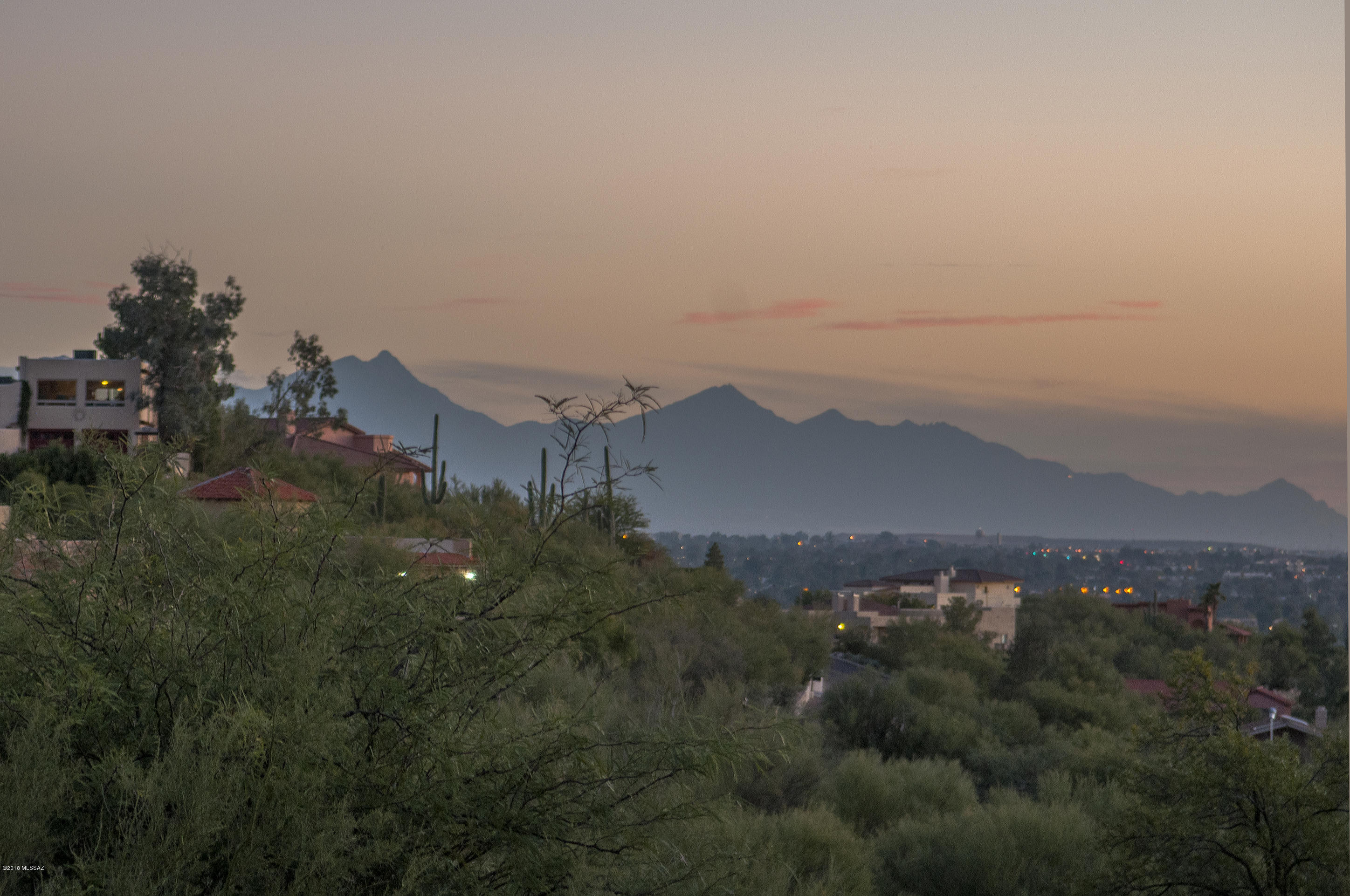 Perfect Foothills Location and what a fabulous price! Look over the pool for the beautiful city-light views, Mountain views to the north. Recently upgraded this foothills ranch is featuring new flooring and freshly painted. Open plan with a contemporary feel. Step down to the living room and walk right out the patio door to the rear yard and pool -perfect for the Tucson Lifestyle. Master bedroom has its own patio, as well. Lovely home situated on .86 acres in the foothills.