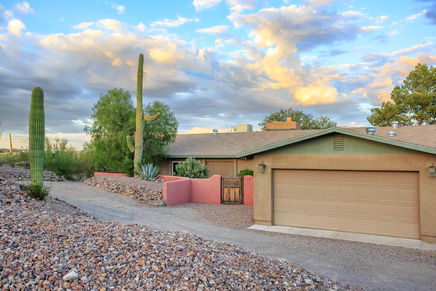 Remodeled in 2017 this Prime west side location close to I10 offers a large private one acre lot with spectacular city & mountain views. Relax and take in the spectacular sights from your newer pebble tec solar heated salt water pool. Enter your home & take in the soaring wood beamed ceilings in your gigantic living room /formal dining room. Huge double fireplace is a statement piece that has been tiled with slate stone. Beautiful kitchen with custom cherry wood cabinets, granite counters and stainless appliances. Great room off Kitchen is perfect for entertaining. Nice sized bedrooms and both baths have been remodeled. Triple pane windows throughout. HUGE 4/5 Car tandem garage is perfect for the car guy, woodworker /workshop. RV space .Owner agent & listing agent is related to seller