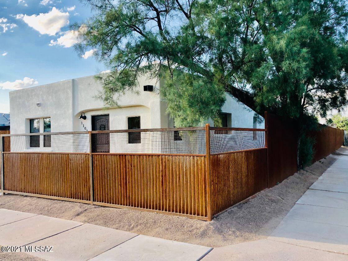 Impressive 1942 Mud Adobe Home located close to Downtown Tucson & Mercado San Agustin!  This 4 bedroom 3 bath home offers a new modern design, with an All New 720sqft Addition coupled to the existing newly renovated 1,282sqft Mud Adobe Home providing natural energy efficiency for cool summers & warm winters.  Exceptional work detail includes, all new roof on addition, new roof on existing, all new elect syst. & panel, all new plumbing to main line, 2 New AC Units 4 ton & 2 ton, new interior walls, texture/paint & trim, natural wood look tile, exposed hand stained wood beams, built in light illuminating nook(s), all new EE dual pane windows, new open kitchen w/space for own inspired island, white apple wood soft close cabinetry with brushed brass knobs, stunning granite countertops, SS GE Appliances, SS brushed gold kitchen faucet, remote ceiling fans with reverse airflow, timing function & color change from cool white to warm white to natural light. New recessed lighting, doors/fixtures & hardware. Spacious Owners Suite & Walk in Closet. Elegant Bathrooms feature Jack n Jill Dual Sink, SS brushed gold 12in rain showerhead systems, waterfall sink faucets, deep tub, walk in showers & gorgeous tile from floor-ceiling. New Exterior Stucco/Paint, new covered corrugated metal porch/concrete patio and new custom corrugated metal fencing all around w/front gate and backyard slide gate vehicle entry. Large lot to make your own - add a small casita, pool, or for RV parking space. New 720sqft addition frame/stucco built. Warranties transfer at zero cost. COT permits obtained, pending build final which is in process. Owner/Agent - licensed to buy/sell real estate in State of AZ.
