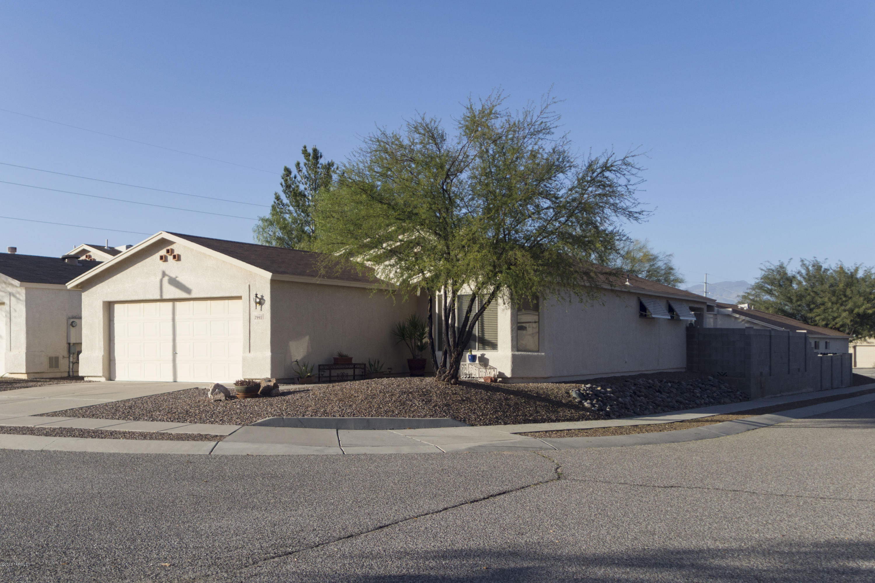 An enticing Eastside home in Enchanted Vista situated on an extra large elevated corner lot. A custom security door welcomes you to an open floor plan.  Ceramic tile guides your journey through this beautifully maintained 3 bedroom/2 bath home. Kitchen boasts a breakfast bar and brightly appointed nook. Awnings on east wall windows of home help balance out daytime sun.  A manicured backyard provides views of the Catalina and Rincon Mountains, equipped with a tranquil fountain and several larger potted plants that convey with the property.  An inviting large master bedroom features a walk-in closest and the other bedrooms with accommodating space for any storage.  The neighborhood is quiet and tucked-away and is lined with street lights.  Seize the opportunity today to make this home YOURS.