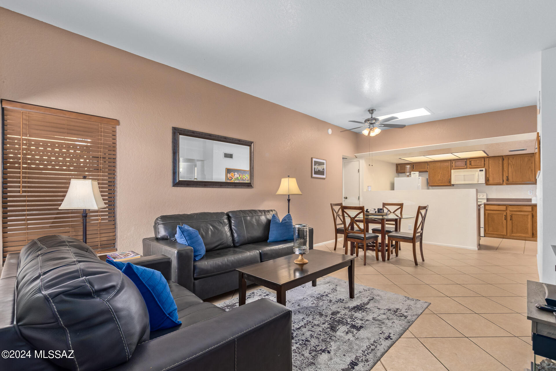 Beautiful corner Townhome located in the private and quiet Creekside neighborhood. This home features tile flooring, tall ceilings, and skylights.  Sliding glass doors in both the master bedroom and the front bedroom lead to a paver patio and expansive courtyard. Spacious 2 car garage with storage leads into the private courtyard as well. Community amenities include a pool area facing the Catalina Mountains, and easy access to the famous River Walk/137 mile loop of paved pathways and bike lanes. Convenient location is close to popular dining and shopping options. The roof was recently recoated and is under warranty. HVAC was replaced in 2023 and the dishwasher was replaced in 2020. Come make this home yours while it's still available! Some furnishings available on a separate bill of sale.