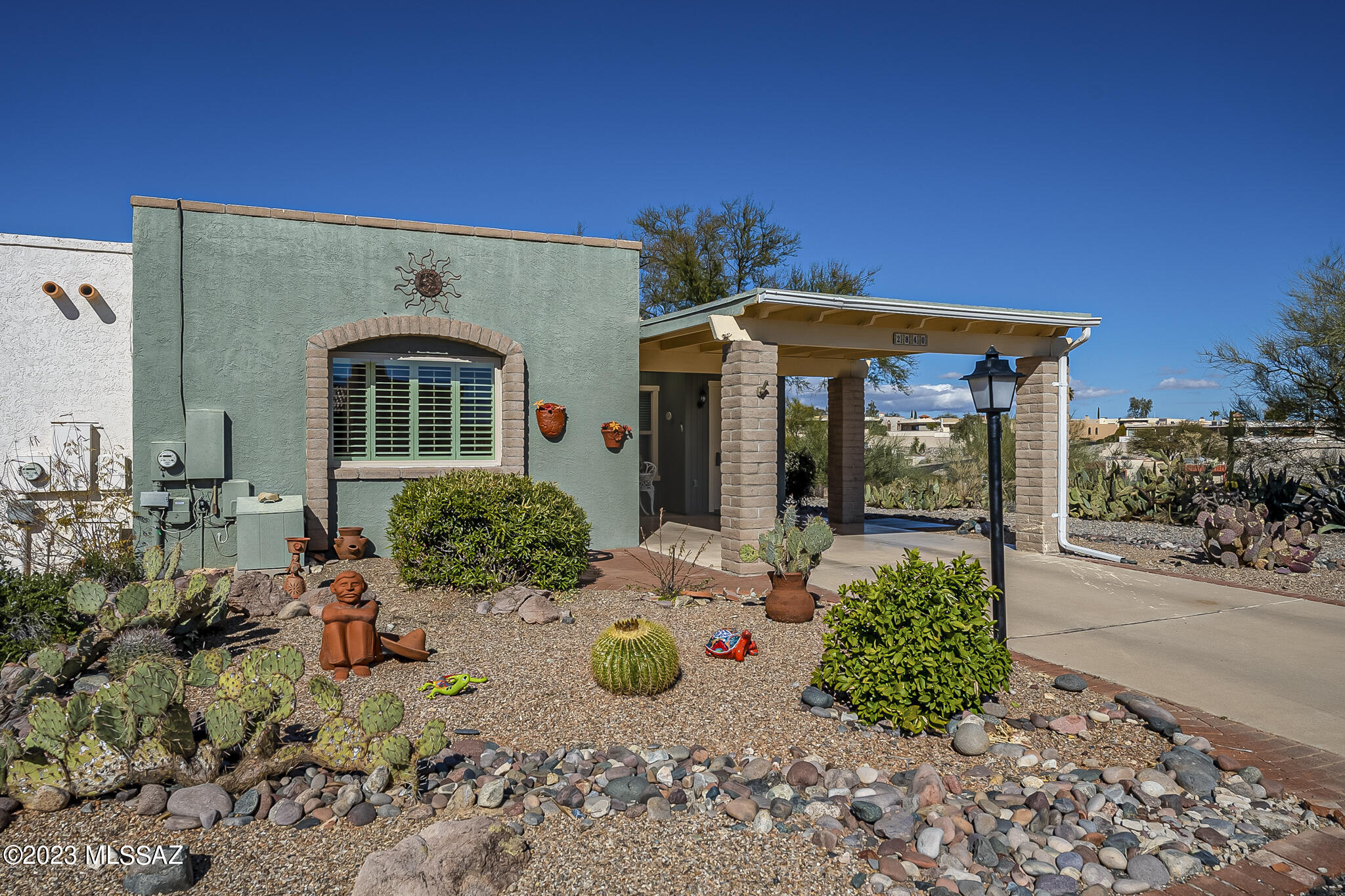 This desirable 2-bedroom, 2-bath end-unit is located in popular Desert Hills 2. The home features an inviting and well-designed layout with southwestern charm, complete with warm and inviting colors, beautiful mountain views, and updated amenities. The bedrooms are well-appointed and offer ample closet space, while the two full baths provide added convenience. The end-unit location of the property provides extra privacy and tranquility for residents, and the beloved mascot, Oscar who should not be disturbed during your stay (He is a packrat deterrent). The backyard and extra storage offers great outdoor living space in our sunny desert environment. The home is also conveniently located near Green Valley Recreation (GVR) facilities.