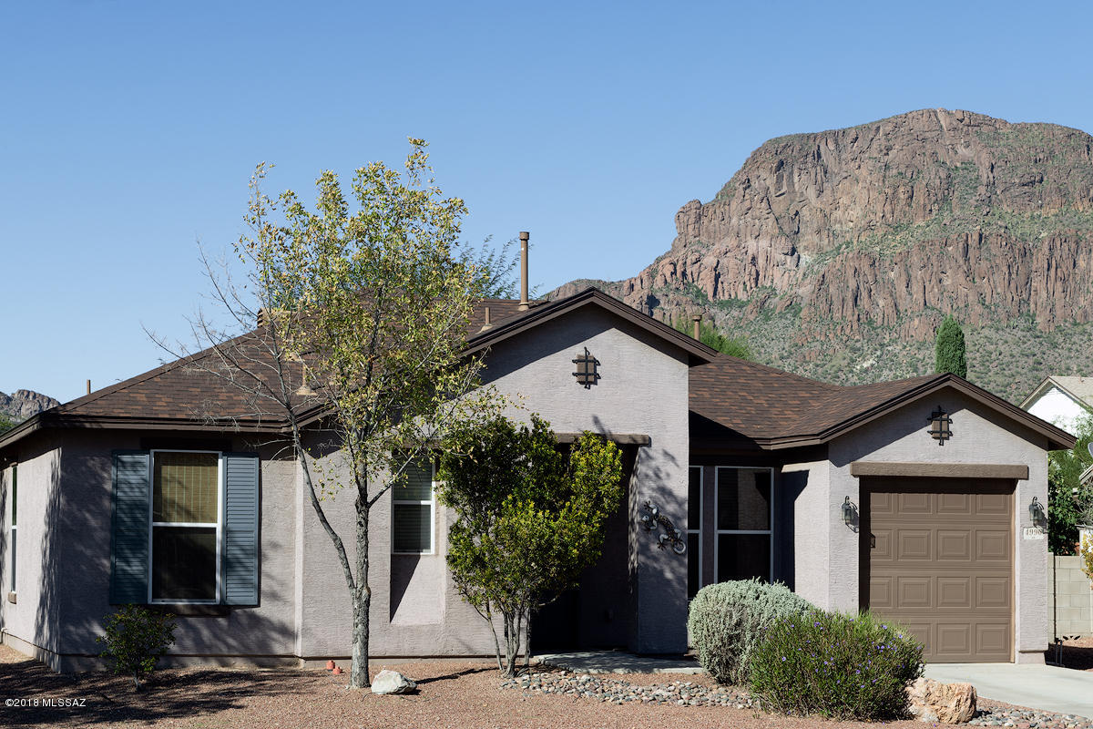 Come see this fantastic 3 bed, 2 bath, 1,422 sq ft residence right in the Southwest part of Tucson! Upgraded kitchen with beautiful new backsplash, new sink and faucet, gas stove, stainless steel appliances, maple cabinetry, light pendants, and a magnificent oversized island ideal for cooking, prepping, and entertaining. The open-concept floor plan features 20'' porcelain tile, 9ft ceilings, ceiling fans in every room, and recessed lighting throughout. Spacious master bedroom complete with walk-in closet and private bath.The large backyard features a beautiful desert landscape with  palm trees, fruit trees, flowering plants, numerous bushes, covered patio, and stunning mountain views. Minutes from I-10, downtown, restaurants, shopping, and so much more!
