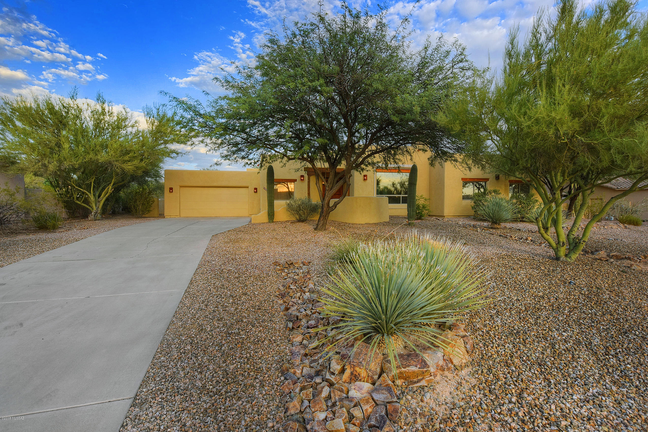 Seller shall entertain and/or counter offers between $400,000 and $450,000. This is the home you've always dreamed about --- This traditional Santa Fe custom home has stunning log poles, high beamed ceilings, talavera tile, huge backyard, and an oversized two car garage. East facing back yard with Pusch Ridge views offer the southwest experience to watch the mountains change color as the sun sets and night descends, coating them in 50 shades of innocent violet and sultry purple.  Pristine southwestern 4-bedroom, 3-bathroom home is situated in a friendly gated neighborhood in beautiful Oro Valley. On just under a 1/2 acre lot, this home will give you 2,580 sq. ft. of generous space to move about.