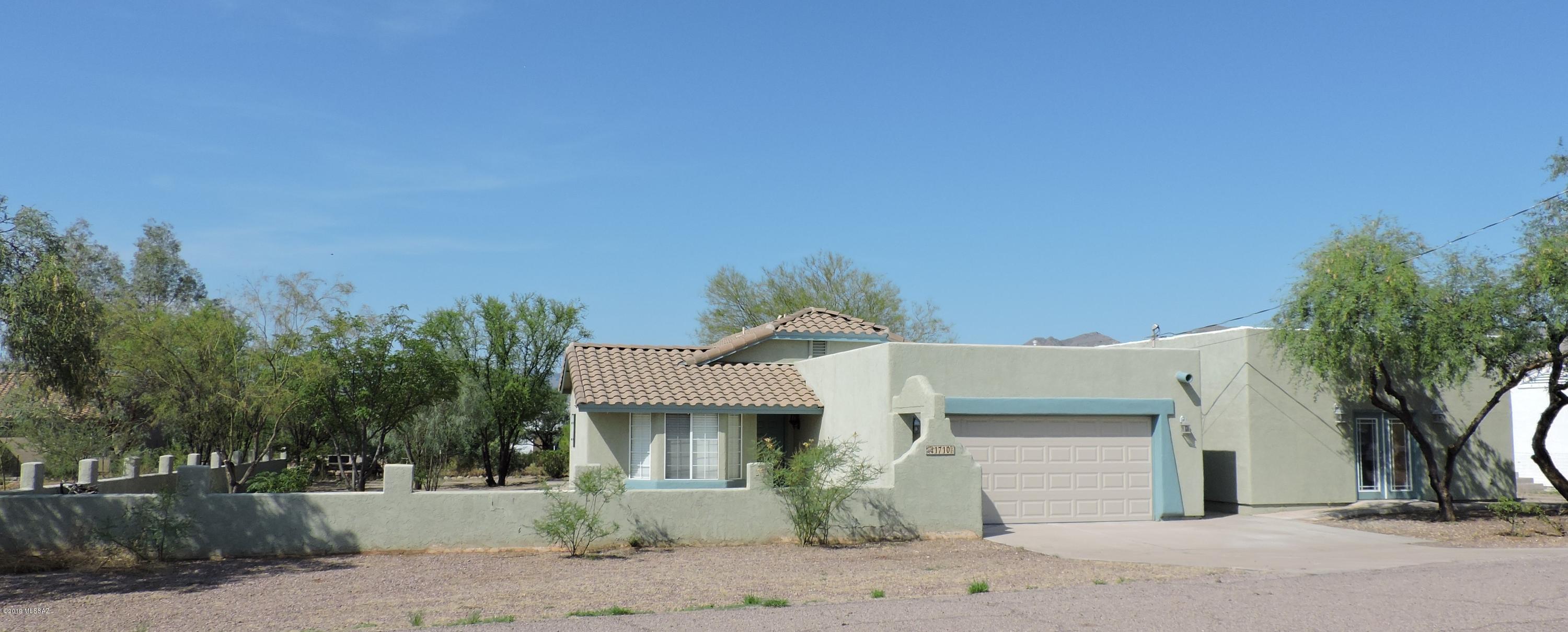Looking for a charming home with room to park your RV & have a workshop? This property is it! Home is updated with new ceiling fans w/remote, new toilets, bath sinks & faucets, stainless gas stove w/vent & window screens, plus interior repainted. Tile floors throughout, breakfast nook, vaulted ceilings, lots of cabinet space in the kitchen, dual sinks in master bath, plant shelves, wall accents. Courtyard entry, large covered side patio & is partially fenced .50 acre. Incredible workshop is a separate 22x24 insulated building w/fans, garage door, entry door & windows, workbench w/multi electrical outlets.  Additional 12x14 slump box storage building w/electricity.  In addition to workshop, attached 2 car garage is finished is wired for ceiling fans. Light & bright & a must see All furnishings available with separate bill of sale.