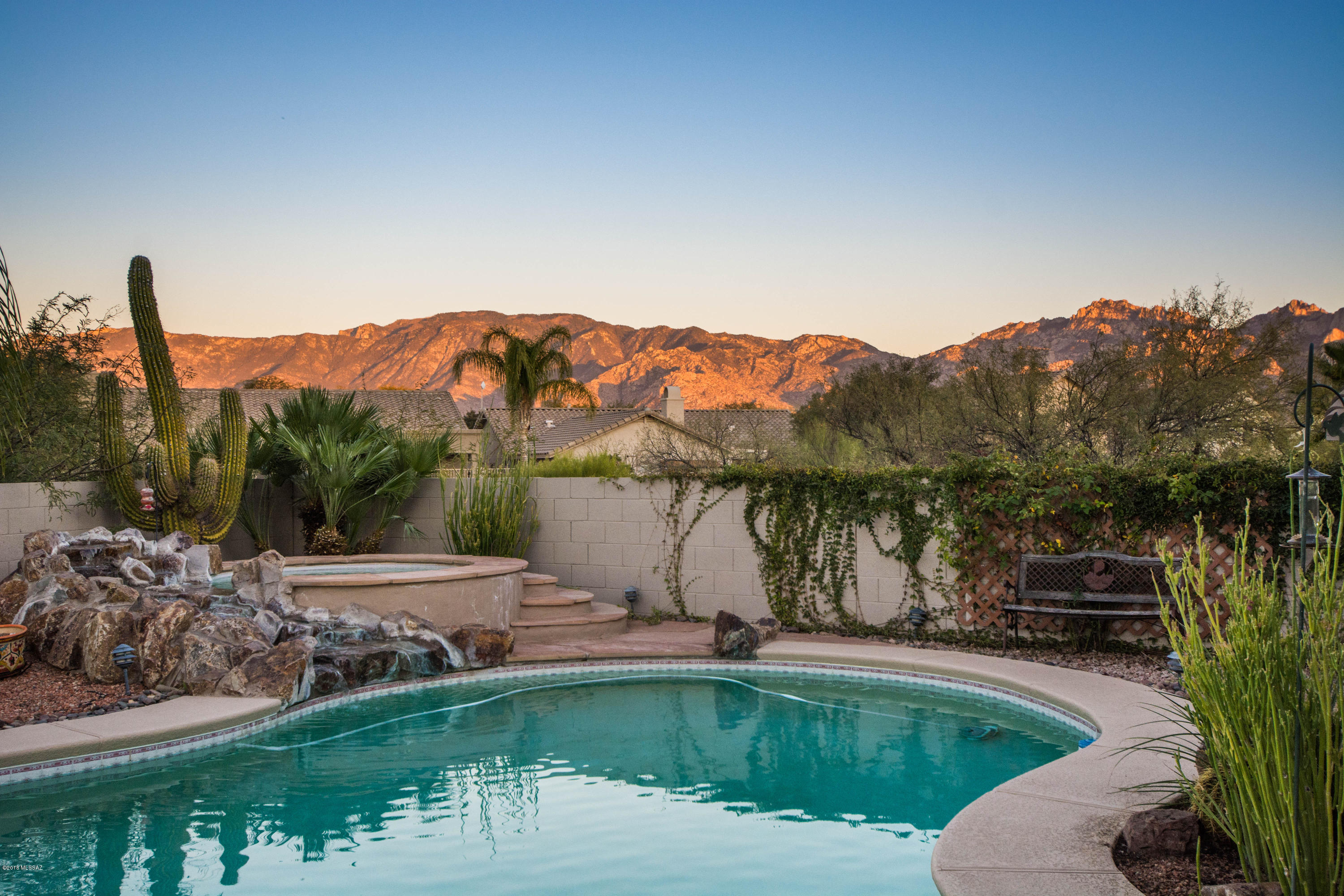 Outstanding Home with views of the Catalina from the eastern exposure backyard that backs up to common area for privacy. This wonderful 5 bedroom, 3 bath home with pool, spa and waterfall will not disappoint! The 2908 sq ft home features, Living/Dining area, Gourmet Kitchen with Stainless Steel refrigerator and tile back splash and built in desk, lots of cabinet space, walk in pantry, breakfast nook, 2 sit up bars. 28' Family Room with gas fireplace with raised hearth and tile surround, Master Bedroom retreat with deck to gaze at the mountains and the moon as it rises. 3 car garage, ceramic tile and wood floors, fantastic backyard with built in BBQ, beehive fireplace and don't forget those stunning Views of the Catalina Mountains. Don't miss this wonderful home!