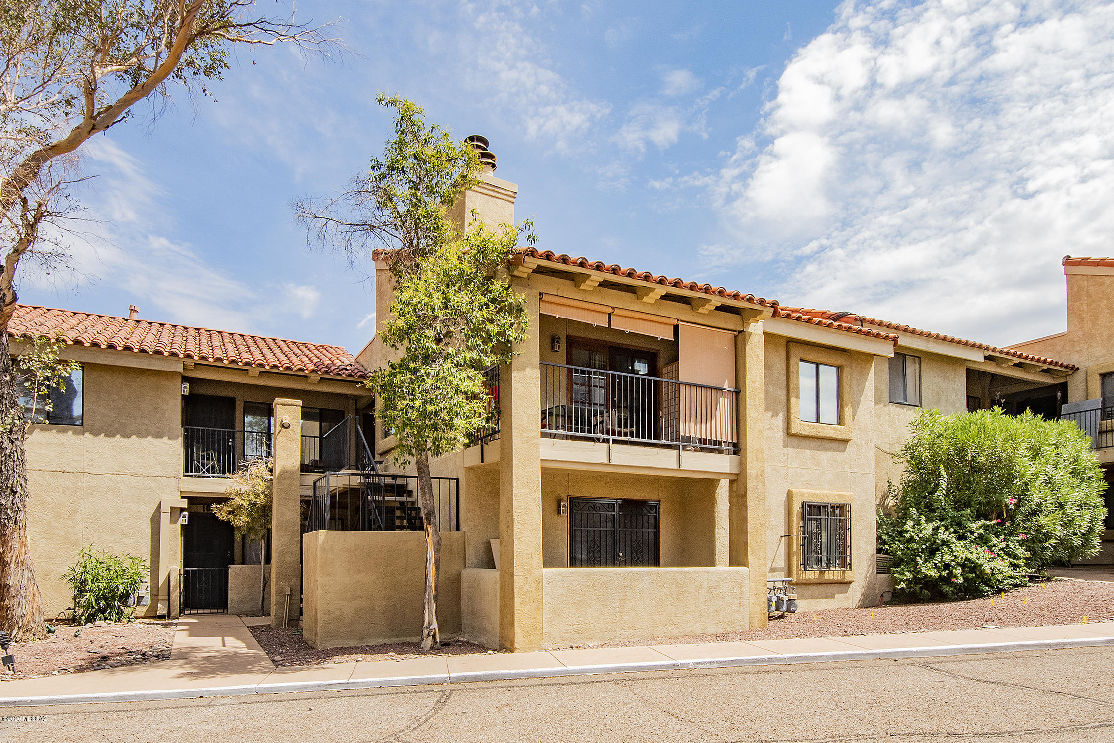 Awesome opportunity to own a condo in the heart of Oro Valley.  Your second story condo features vaulted ceiling with a private balcony and views of the Catalina Mountains.  This two-bedroom two-bathroom condominium has upgraded laminate flooring, less than one year-old Air-Conditioning unit, a double stack washer/dryer, and a Sante Fe style wood burning fireplace.  Conveniently located close to shopping, restaurants and other amenities just off Oracle Road.