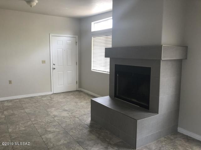 Centrally located near the Tucson Racquet & Fitness Club, this 3 bedroom, 2 bath duplex has new tile flooring throughout, granite countertops in the kitchen as well as newer appliances. All electric with no gas available. Wood burning fireplace located in the living room. Electric washer/dryer hookups available on the back patio. Off street parking with easy access to shopping, restaurants and the UofA. One small dog or cat allowed (under 30 lbs) with potentially refundable $250 deposit.  A refundable security deposit of $1000 is required at the time of signing the lease. By law, the refundable security deposit may not be used as last month's rent by the tenant. The security deposit will be used to repair any damage to the unit (i.e. broken blinds, damage to walls or baseboards, broken shelves in refrigerator, broken windows, broken tile). Tenant will need to sign a Pima County crime free policy. A $200 non-refundable cleaning fee is required.  A $500 deposit will be required to secure the unit. This will be applied to the first month's rent or refunded if not selected.