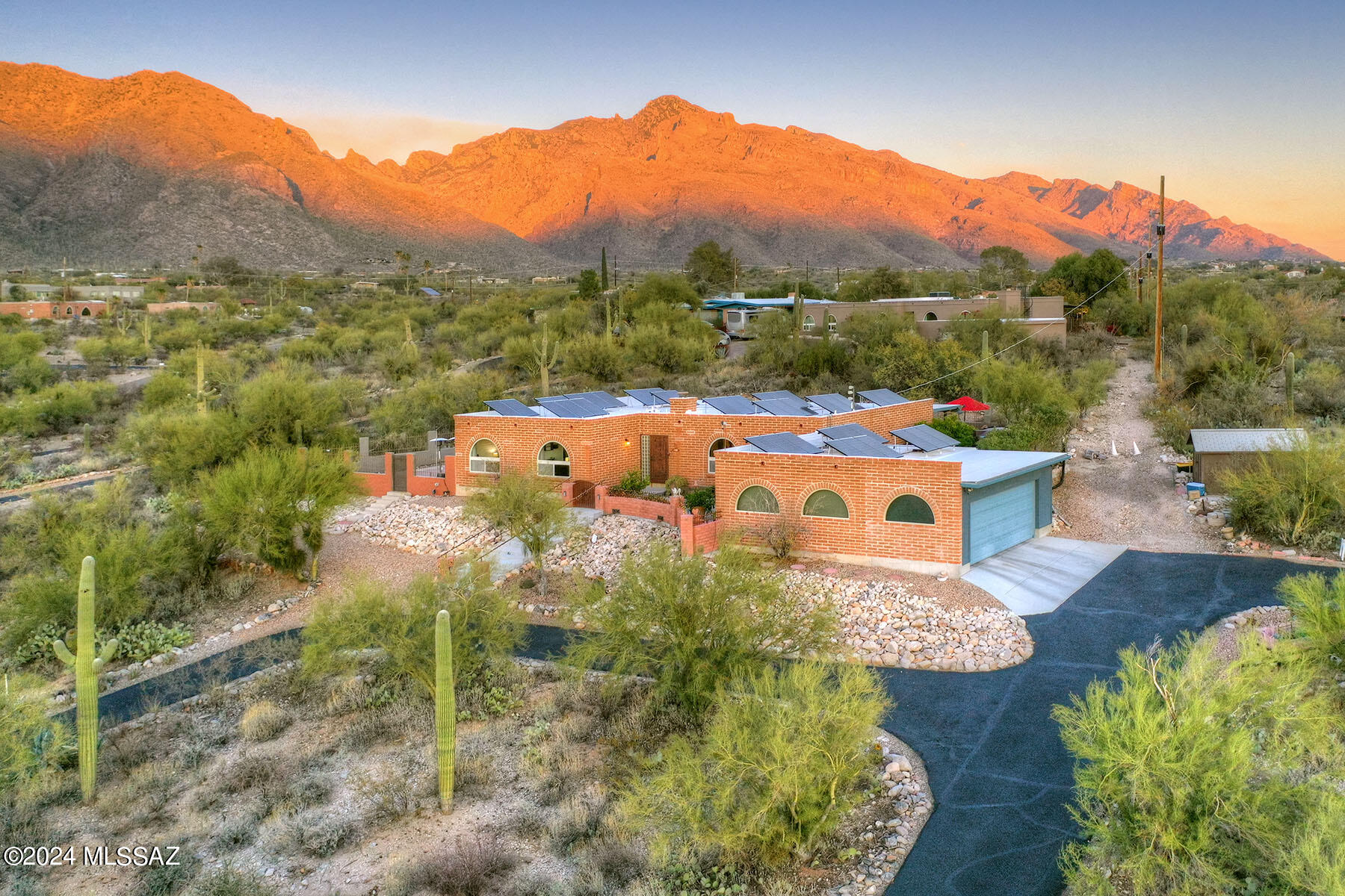 Please schedule appointment for showing. Wonderfully remodeled and updated burnt adobe territorial style home, high on a hill in the Catalina Foothills with sweeping city and mountain views.  With 4 bedrooms, 2 baths and 2,096 sq. ft., this gorgeous home is in move-in condition.   Located on a 1.039 acre cul-de-sac lot, circular driveway leads to courtyard, into foyer and the kitchen/family room with LVT flooring.  Remodeled kitchen offers an abundance of cabinetry, quartz counters, stainless steel appliances and burnt adobe beehive fireplace.  Expansive living and dining room, updated primary suite and bath with granite counters, walk-in shower and closet.  Glorious rear yard has expansive covered porch, pool and hot tub.  Generous two car garage, voluntary HOA, water harvesting system, prepaid leased solar (no lease payments or transfer fee)  and includes all maintenance and insurance.  See to appreciate this beautiful home.