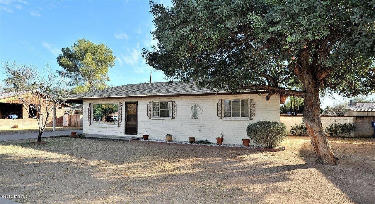 This well-maintained classic home is JUST WHAT YOU'VE BEEN WAITING FOR! It's located in the heart of Tucson and near Mesa Village Park. It features a formal living room and a separate family room with vaulted ceilings and a raised-hearth, bricked fireplace. Updates include: new carpet (12/16) throughout most of the home,  roof replaced in 2013, interior water lines replaced in 2012, exterior water line replaced in 2009 and the gas line replaced in 2004. Dual pane windows in the family addition and living room.  The indoor laundry room with sink offers plenty of storage space. Oversized walled rear yard with mature landscaping. The family room addition is cooled by its own evaporative cooler and has baseboard heating. Come take a look today!