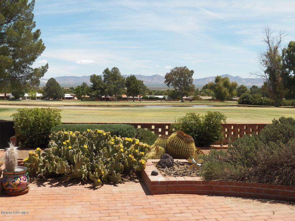 This 2BR 2BA home is secondary to the spectacular view. Welcome to a desert oasis where you will gaze over 4 holes of Haven golf course to our majestic Santa Rita Mtns. On the way notice 2 sparkling lakes enjoyed by various waterfowl, tall pine trees and lush, green grass. Begin and end your day with this enormous view relaxing on the patio or sitting in the great room curled up in front of the corner fireplace. New HVAC unit installed 2012. Property sold in As-Is condition. Currently not a member of GV Recreation but buy-in is available.