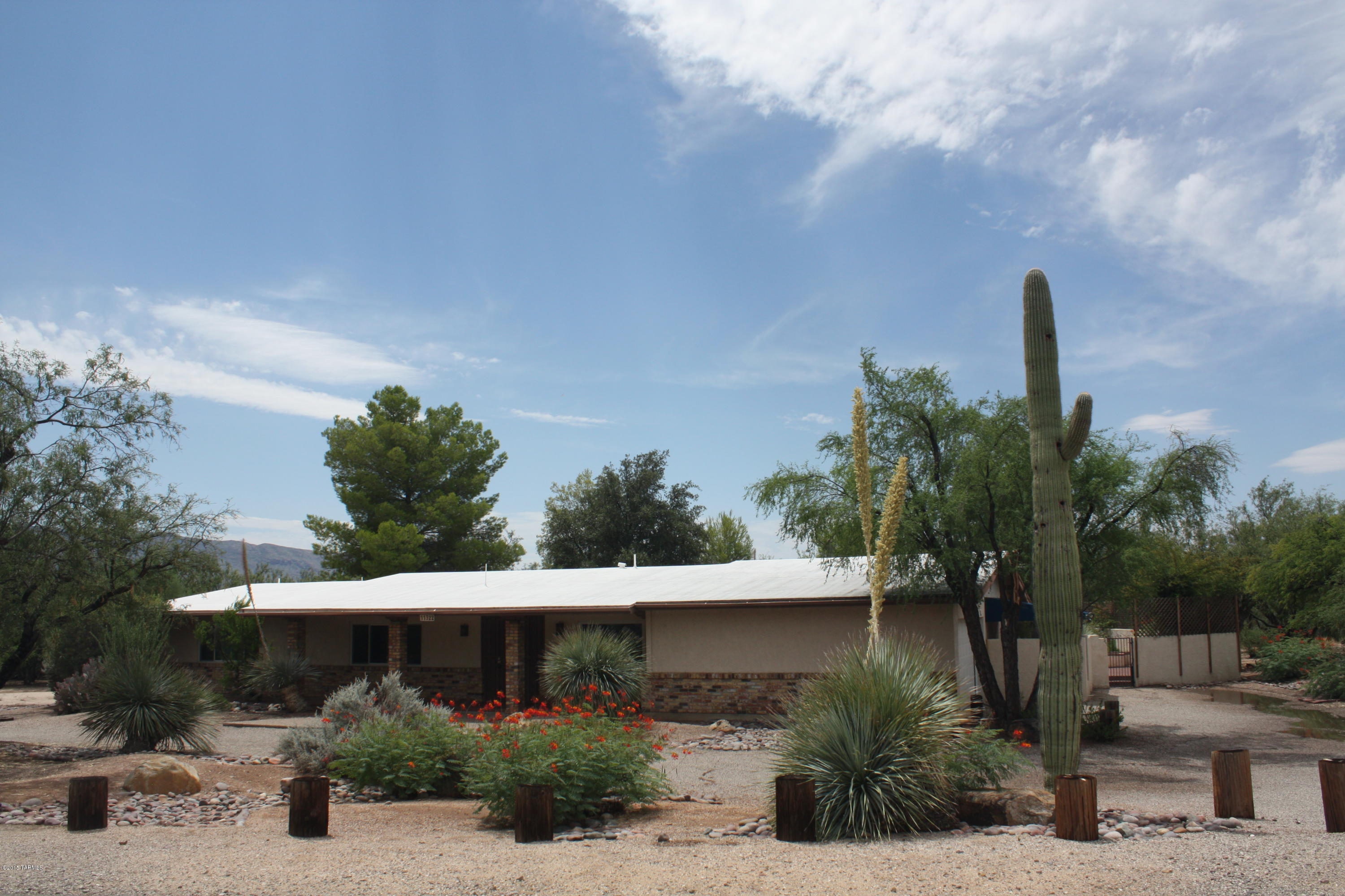 Great home in Bel Aire Ranch Estates on over an acre. Tanque Verde School District, 2 car garage, triple pane windows, 2 water heaters, and formal dining highlight the features of this solid home. You must see the beautiful backyard with pond, waterfall, fountain, covered patio and fire pit! Owner pays for Landscaping and fountain/pond service.