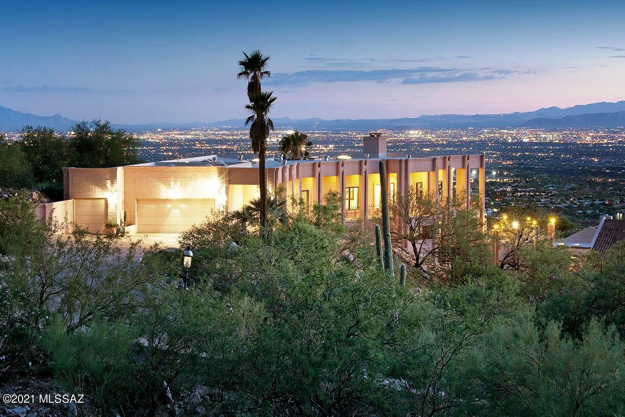 Rare Opportunity to experience Sky-high Living in Prestigious Skyline Country Club Estates, in this Architecturally Designed Modern Classic perched on an Aerial Lot, with Panoramic Views that extend into each and every room through sprawling patios and terraces, bands of windows and doors.  Eye-catching Curb Appeal, deep setback Circular Drive and Majestic Elevation, beautifully integrate with the Natural Environment.  A Design-forward floor plan with functional flexibility, clean lines, lots of natural light and ''Great Bones,'' of course.  The entire lower level is dedicated to a Private Guest Quarters with it's own entrance, and includes a living room w/fireplace, complete kitchen, bedroom and full bathroom -- Perfect for the Modern Lifestyle!  You'll be impressed, yet feel right at home in this lovingly maintained, one-of-a-kind residence.  Close to Everything, Yet Away from it All!  Skyline Country Club is a Guard Gated Community carved into the pristine Foothills of the Santa Catalina Mountains, where you can enjoy some of the most spectacular scenery of any Golf Course Community in the entire southwest, with Hiking Trails and Wildlife just outside your door.  Limited Club Amenities included in HOA dues, or become a Country Club Member with full membership privileges.  Don't let this one get away!