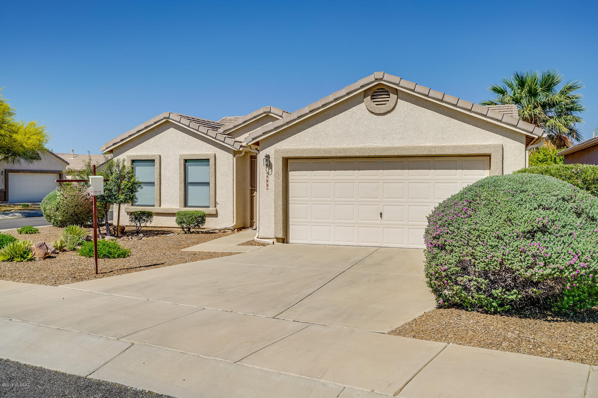 Bright and lovely two-bedroom home on corner lot near community pool and spa, and parking lot; with larger back yard with trees, fountain, covered patio with automatic screen. House has vaulted ceilings, open floor plan with hickory laminate flooring (carpet in master bedroom) Kitchen has Corian counter tops, subway title, backsplash, roll-out shelves, breakfast bar, gas range, new appliances; also ceiling fans, skylight in kitchen; water softener and reverse osmosis; and enclosed entry. This gated 55+ community also has access to adjacent voyager RV Resort with its pools, spas, restaurant, credit union, day spa, pickle ball, golf, tennis, crafts, fitness center, entertainment and much more. Come and enjoy life at this active adult community.