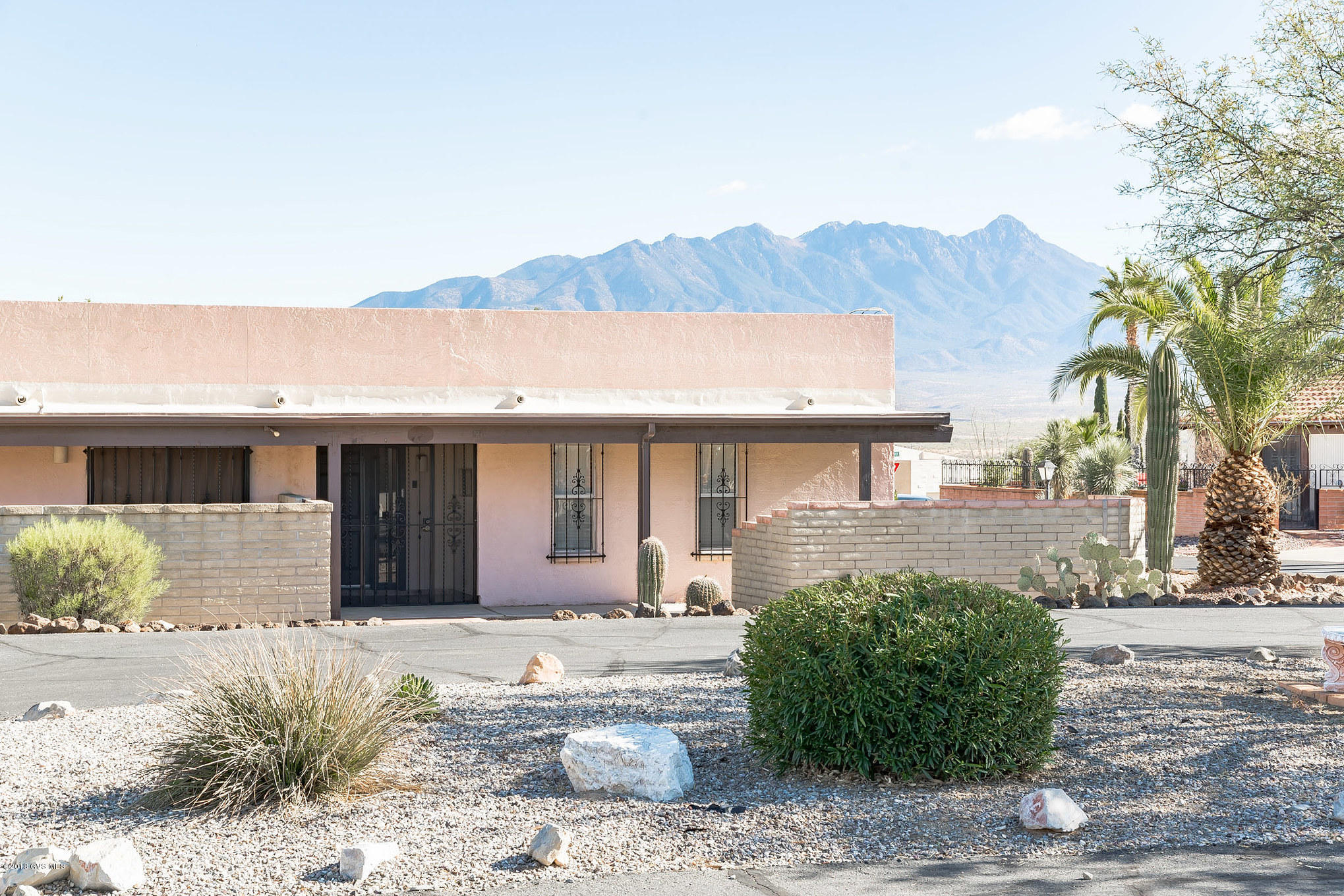 WOW...if you are looking for a view (this one has magnificent partial view of the Santa Ritas) & a house that has been updated...look no further. Ideally located in DH 2, this lovely home has an Atrium that brings light streaming into the interior of the home, & boasts an updated kitchen & master bath. New appliances were installed in 2012 but owner only lived part-time until 2016. In 2016 she replaced the refrigerator. The microwave is original. In 2016, the master bath was remodeled to include: walk-in tile shower w/seat, hand-held and rain shower heads, 3 grab bars, non-skid flooring, and executive height counter w/granite. There is a large screened-in AZ room. In back you'll find easy care landscaping giving you plenty of time to enjoy all the amenities Green Valley offers.