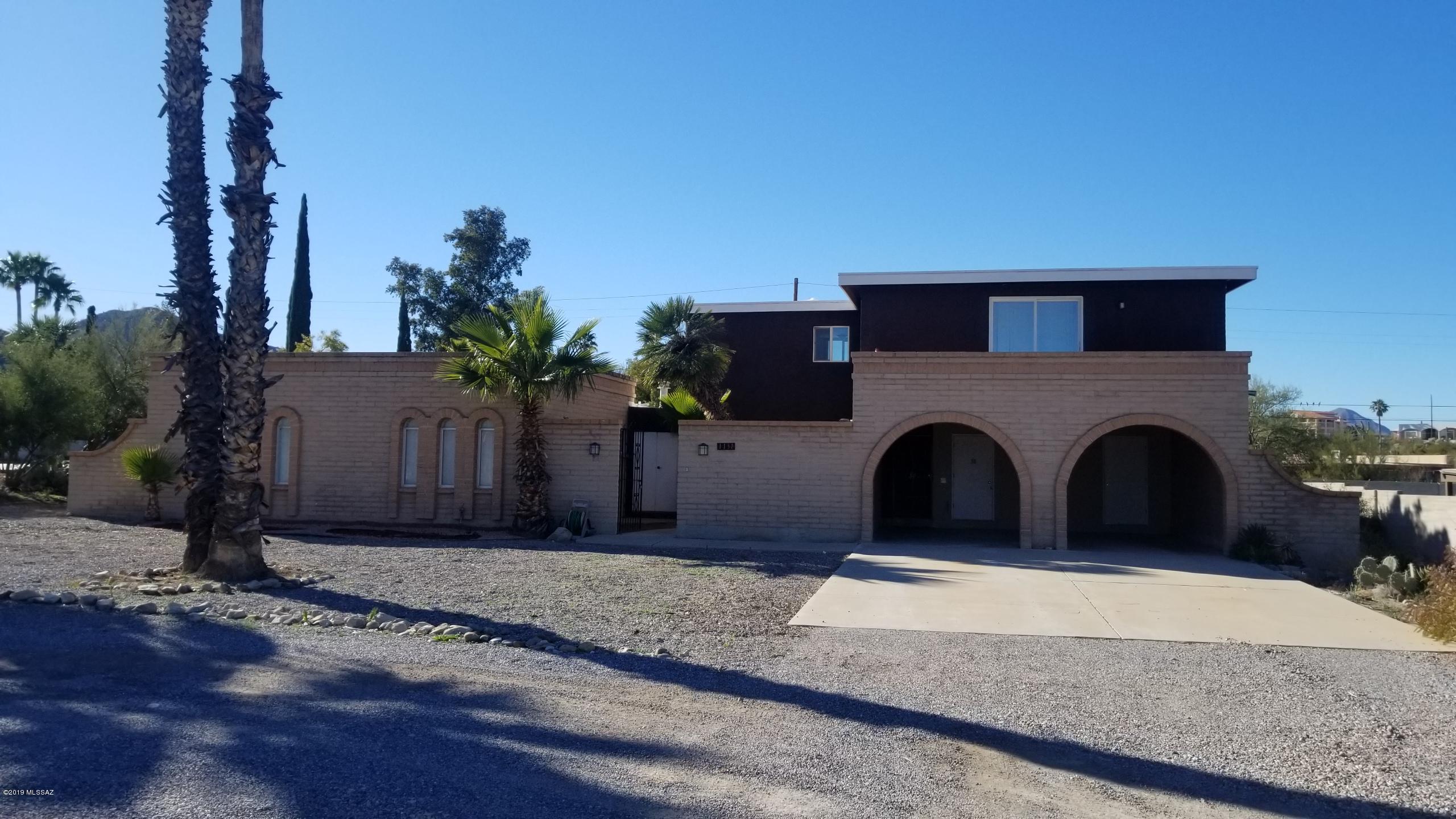 Spacious living near the heart of Tucson.  Over 3000 sf on 1/3 acre with beautiful mountain views from the balcony. This home offers a split floor plan with the master bedroom upstairs and remaining 3 bedrooms downstairs. Guest bathroom has 2 separate showers. All granite counter tops, dual-pane windows, an over-sized fireplace, and convenient storage in the carport. Large pool and covered patio are perfect for hosting guests. Plenty of parking, vehicle gate and space for an RV. No HOA! Located only 2.8 miles from the I-10 fwy. Owner/Agent.