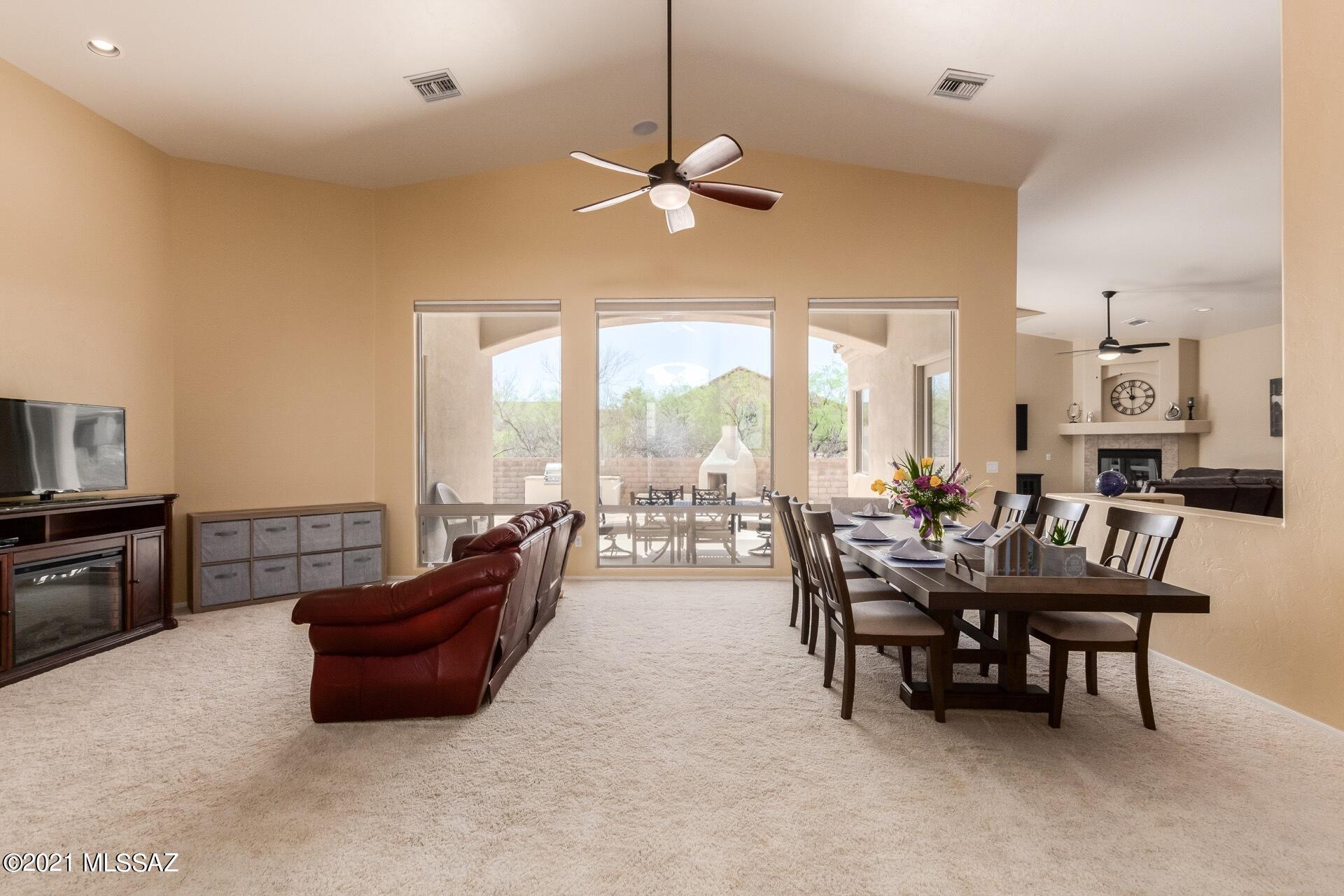 Move in ready, semi-custom home on nearly ½ an acre in Vail, AZ. Stunning features throughout with vaulted ceilings nearing 16', large windows with plenty of natural light & an open floor concept perfect for large gatherings. Kitchen has granite countertops, large island, stainless steel appliances& upgraded custom cabinetry.  The rest of the home features 3 large bedrooms plus an office/den, indoor gas fireplace, whole house RO water filtration system, built in living room surround sound & whole house interior/exterior speaker system.  The front & back yards are beautifully landscaped, & low maintenance with timed drip system.  The backyard comes with built in BBQ & fireplace with travertine countertops, large high end grass area with fountain. This home offers tons of privacy.