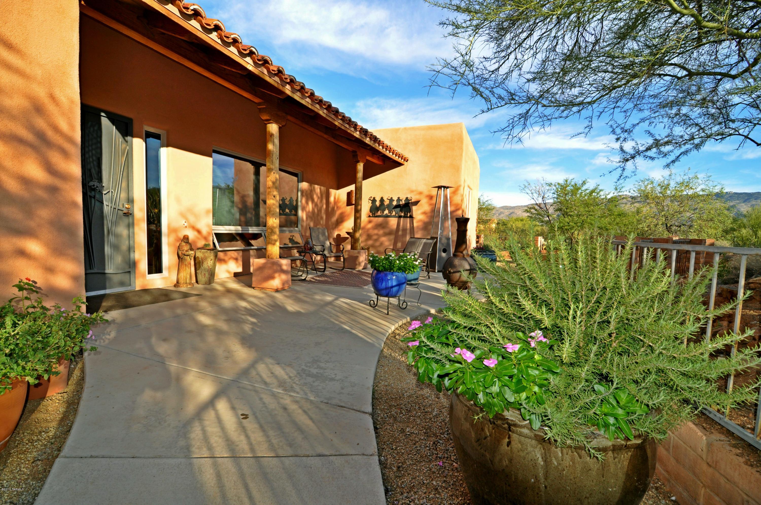 An Amazing Lifestyle awaits in gated, Coyote Creek! Walking Trails, Equestrian Facility, & Rec Center! Inviting, Elegant Southwestern Architecture. The emphasis is on quality! Wander through the lush courtyard to the formal entry. Discover the Great Room! Soaring ceilings, rough-sawn beam & Viga accents, gorgeous tile. Nearly floor to ceiling windows capture Rincon Peak views. Wood clad, Anderson windows & doors. Wonderfully designed, gourmet kitchen w/unique granite, knotty alder cabinetry & SS appliances-including beverage fridge. The backyard is a WOW! Backs to common area wash. The curved, wrap-around patio is deep enough for entertaining & is elevated above the generously walled yard w/view fence. Grass, trees & native plantings. One owner has AZ Real Estate License.