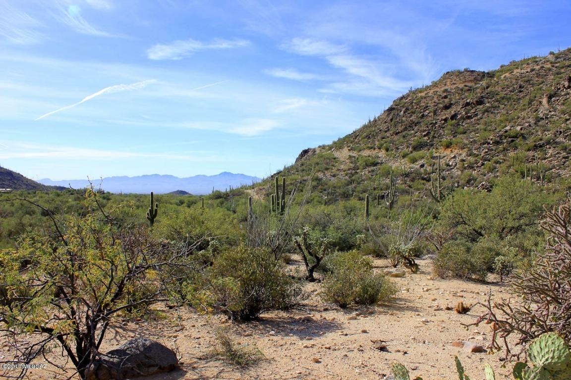 Spectacular 2.68 Ac build lot in the picturesque, luxury guard-gated community of Canyon Pass at Dove Mountain. Lot features include panoramic views of the Canyon and Valley lights plus native saguaros and rock outcroppings. Ready to build with surveys completed, water meter installed and sewer fee paid. Located in the front half of the Canyon just minutes from the gate. Dove Mountain is home to the Ritz-Carlton Resort and Gallery Golf & Sports Club with close proximity to I-10, hiking/biking trails, fine dining and retail in the high Sonoran Desert.