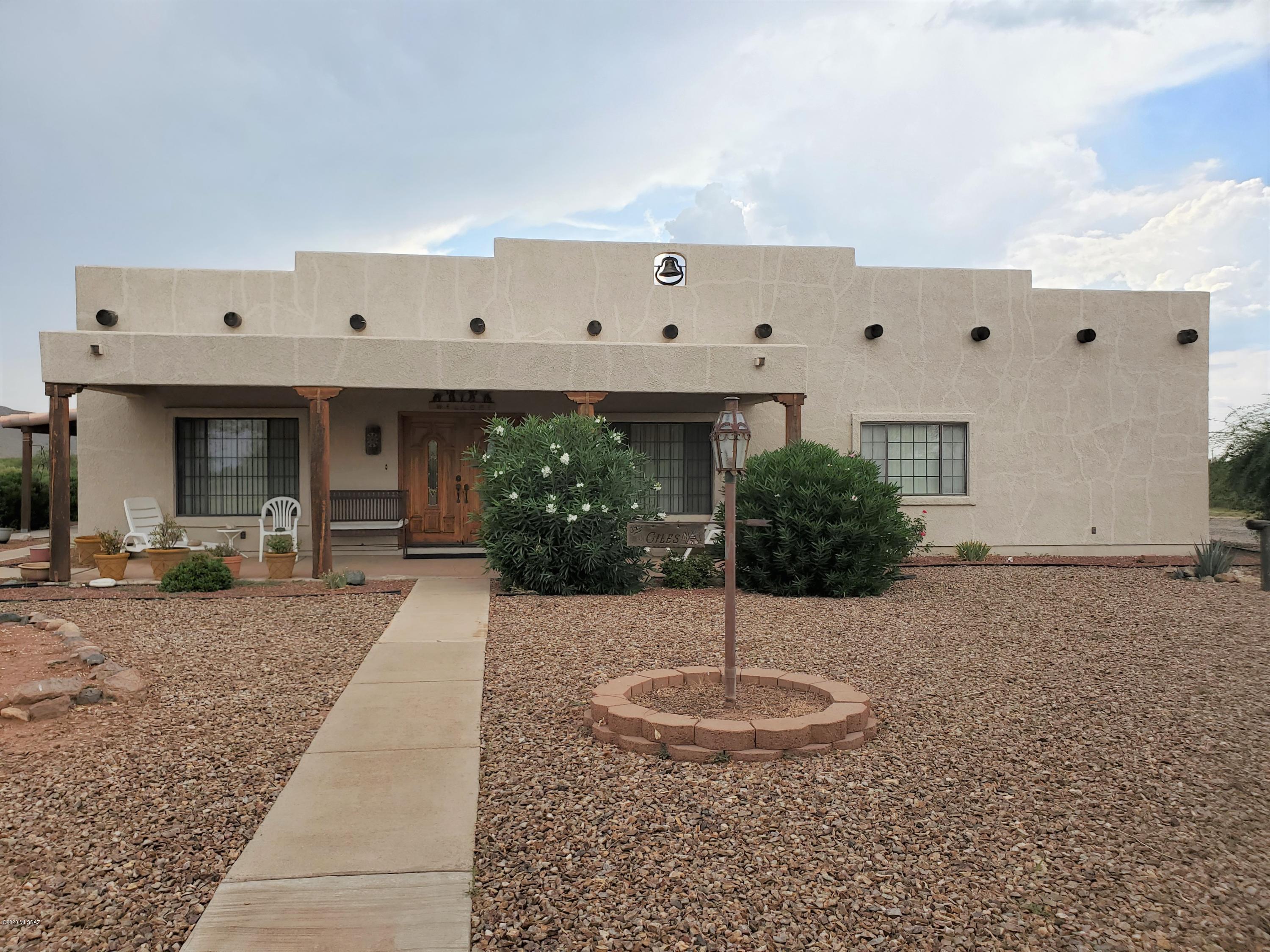 Get out of the city and relocate to the  peace and quiet of the high desert valley with mild year round temperatures and starry night skies! Gorgeous custom built home total of 40 Acres of flat terrain on paved road. Original owner built 'dream home'' and occupied since 2001. Attention to detail evident in every inch of this home. Solid 2 x 6 framed w/ 10'' ceilings, custom oak cabinets w/pullouts in kitchen, wet coffee bar, breakfast bar and nook.  SW style accents with wet bar and fireplace in large living room. 2 bedrooms with huge master bath equipped with jacuzzi and vanity area. Den would make a great guest room or office. 1200 sq.ft garage w/ 1 insulated room and another  framed and plumbed workshop. Target range at rear fenced 5 acres. Perfect for equestrians or vineyard... along with tasting room! The Willcox Bench wine growing area produces 3/4 of the wine grapes in Arizona. The perfect elevation, soil and sunshine is perfect for grape growing.